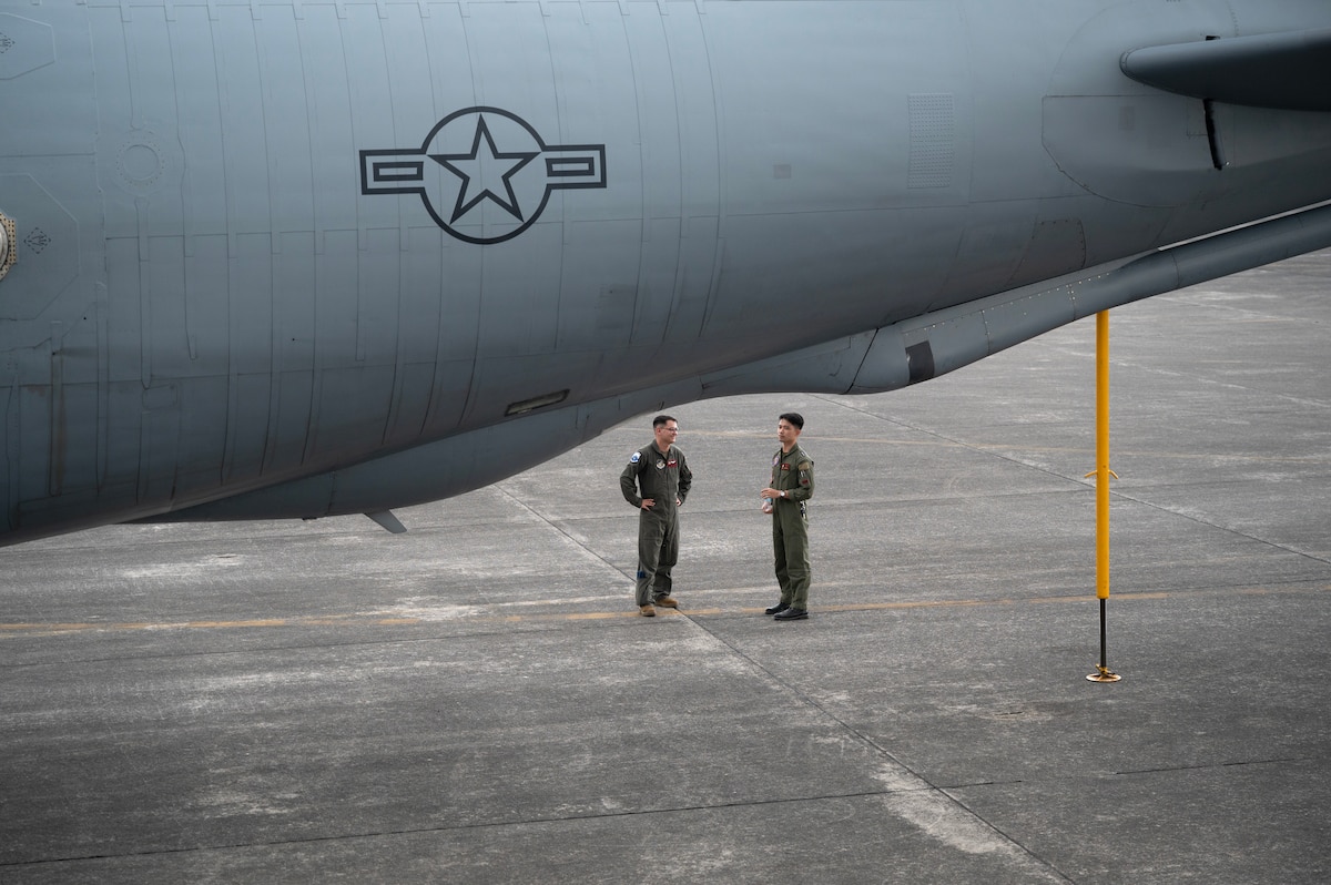 U.S. Air Force Senior Airman Christian Lawhorn, 909th Air Refueling Squadron boom operator, discusses aerial refueling capabilities with a Philippine Air Force pilot during a static aircraft tour at Clark Air Base, Philippines, March 13, 2023. Bilateral training and cooperation with our Philippine Air Force counterparts enhances the mutual readiness required to defend security, prosperity, and peace throughout the Indo-Pacific region. (U.S. Air Force photo by Senior Airman Jessi Roth)