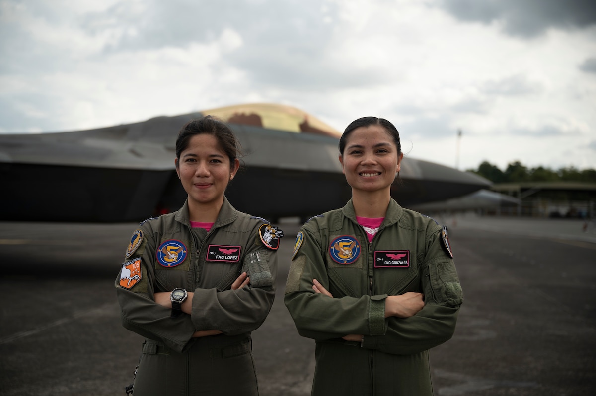 Philippine Air Force pilots pose for a photo in front of an F-22A Raptor in honor of Women's History Month during a static aircraft tour at Clark Air Base, Philippines, March 13, 2023. Integrating and training alongside the Philippine Air Force promotes interoperability, builds upon our strong alliance, and reaffirms the commitment to the Mutual Defense Treaty and maintaining peace and stability throughout the Indo-Pacific region. (U.S. Air Force photo by Senior Airman Jessi Roth)