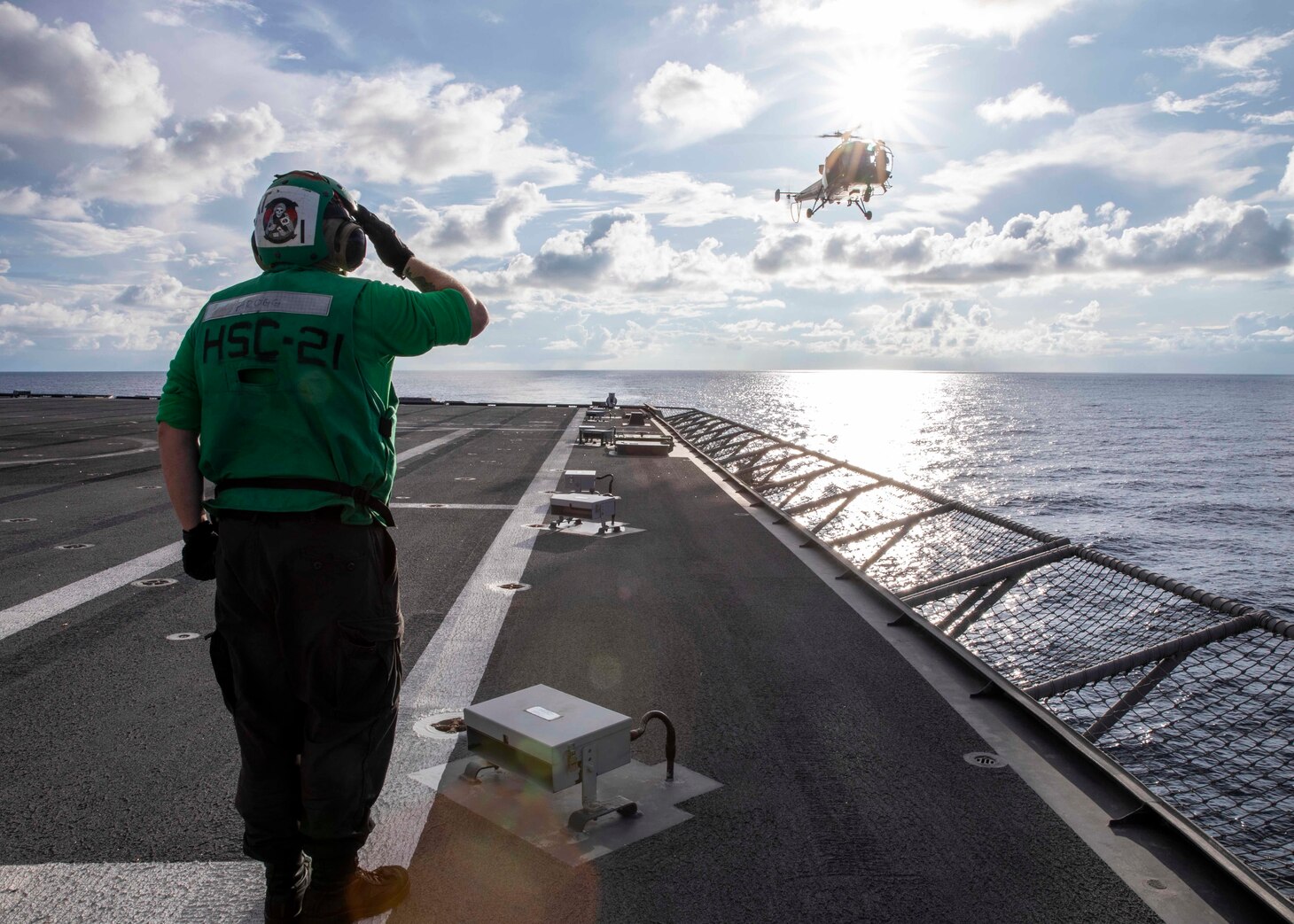 Aviation Electronics Technician 3rd Class Carson Fogg, from Sacramento, California, salutes the pilots of an Indian Navy HAL Chetak Alouette III after take-off from the flight deck aboard Independence-variant littoral combat ship USS Charleston (LCS 18) during joint training exercise La Pérouse 2023 in the Bay of Bengal, March 13. La Pérouse is a multilateral exercise designed to enhance cooperation in the field of maritime surveillance, interdiction operations and air operations by progressive training and information sharing. Charleston, part of Destroyer Squadron 7, is on a rotational deployment, operating in the U.S. 7th Fleet area of operations to enhance interoperability with Allies and partners and serve as a ready-response force in support of a free and open Indo-Pacific region