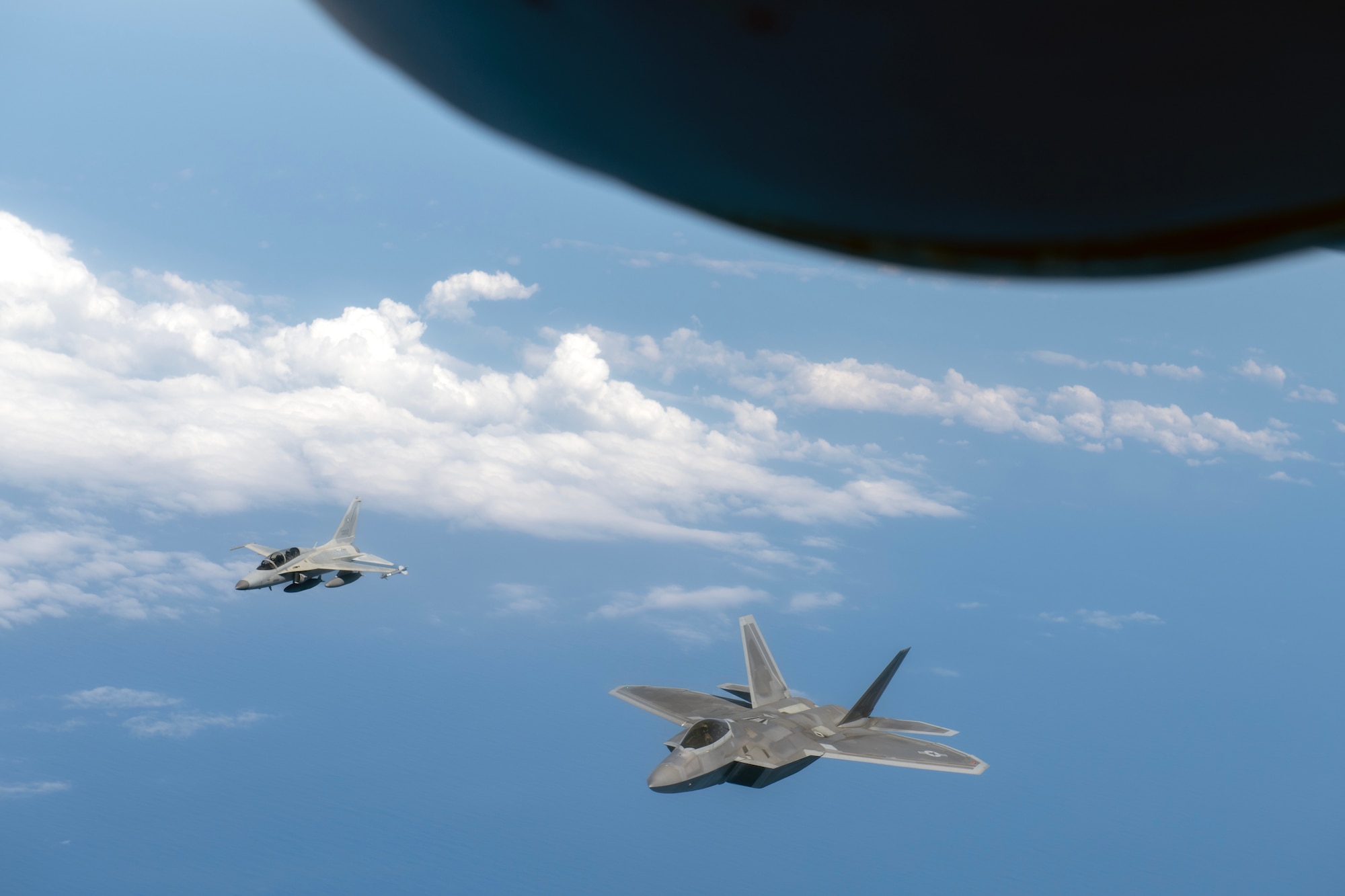 An F-22A Raptor assigned to the 525th Fighter Squadron flies side by side with a Philippine Air Force FA-50PH over the South China Sea, March 14, 2023. Enhancing interoperability between the U.S. and Philippine air forces contributes to the long-term advancement of our nations’ shared interest in maintaining a free and open Indo-Pacific. (U.S. Air Force photo by Senior Airman Jessi Roth)