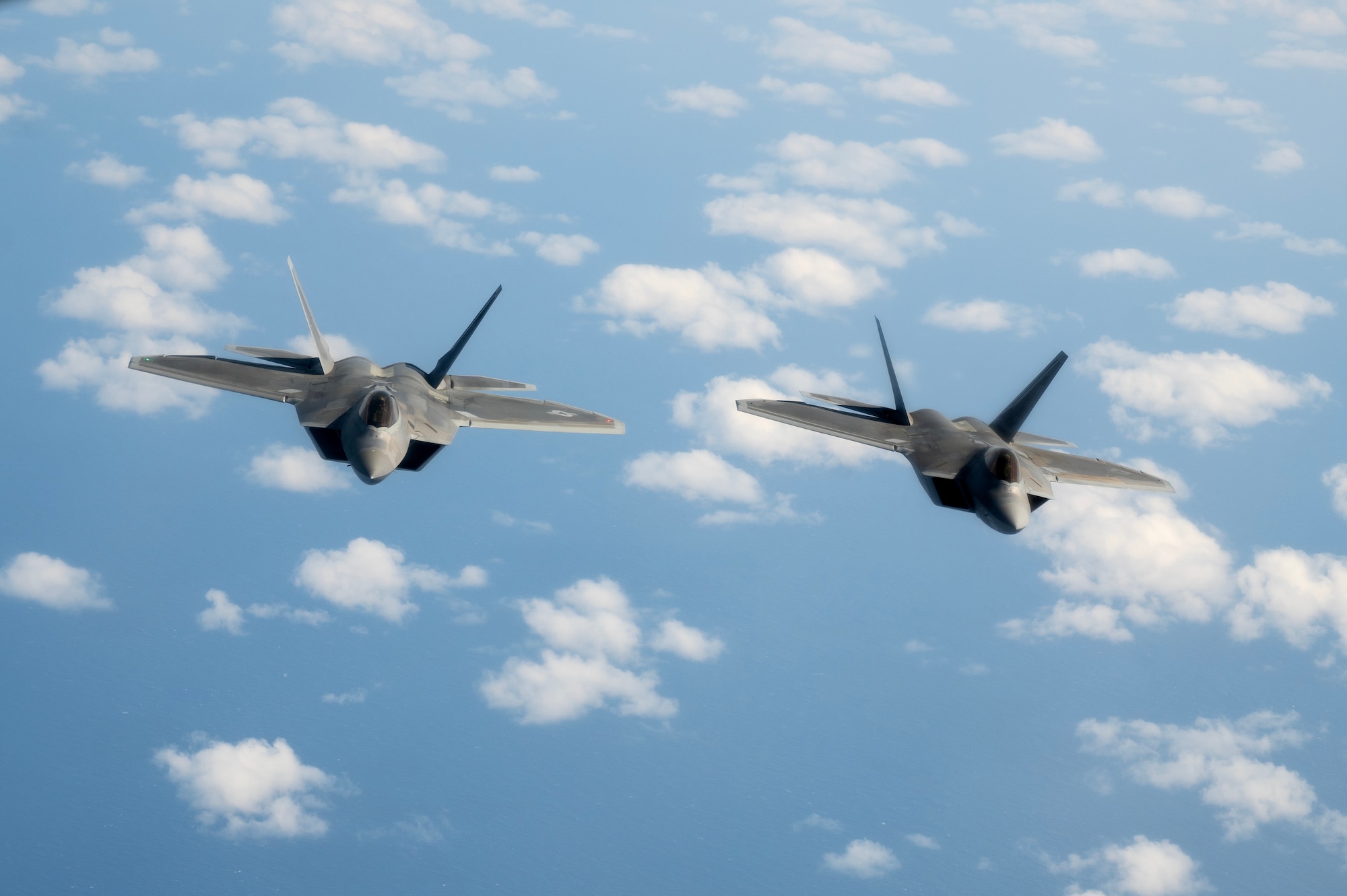 F-22A Raptors assigned to the 525th Fighter Squadron fly behind a KC-135 Stratotanker over the South China Sea, March 13, 2023. The Raptors flew to Clark Air Base, Philippines, where they integrated with FA-50PH pilots from the Philippine Air Force’s 5th Fighter Wing to exchange expertise and engage in aerial training. (U.S. Air Force photo by Senior Airman Jessi Roth)