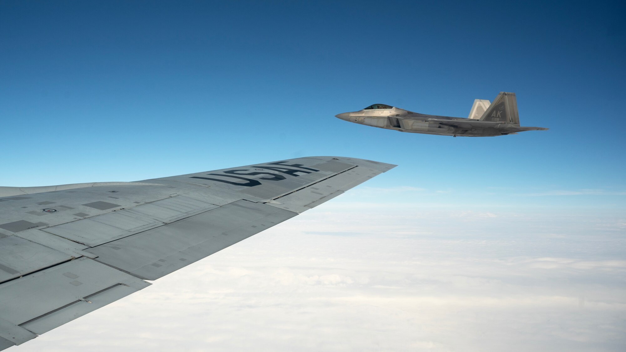 An F-22A Raptor assigned to the 525th Fighter Squadron flies alongside a KC-135 Stratotanker over the South China Sea, March 13, 2023 in support of a subject matter expert exchange and bilateral training mission with the Philippine Air Force. Bilateral training and cooperation with our Philippine Air Force counterparts enhances the mutual readiness required to defend security, prosperity, and peace throughout the Indo-Pacific region. (U.S. Air Force photo by Senior Airman Jessi Roth)