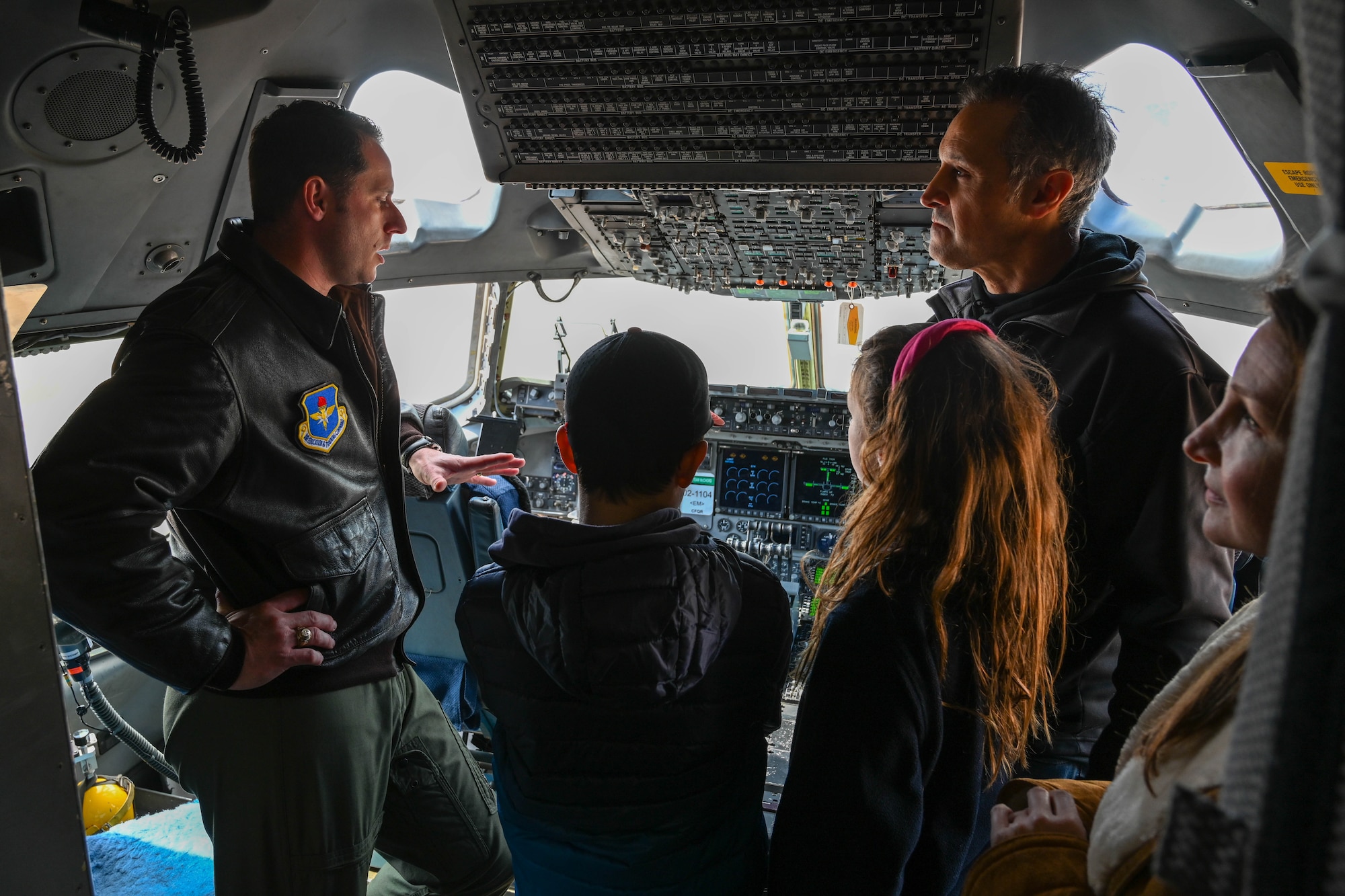 U.S. Air Force Lt. Col. John Shaw, 58th Airlift Squadron director of operations, talks about elements in the cockpit in a C-17 Globemaster III at Altus Air Force Base, Oklahoma, March 14, 2023. During their time on base, the Leadership Oklahoma members had a chance to tour a static C-17 and ask aircrew members questions about the aircraft. (U.S. Air Force photo by Senior Airman Trenton Jancze)