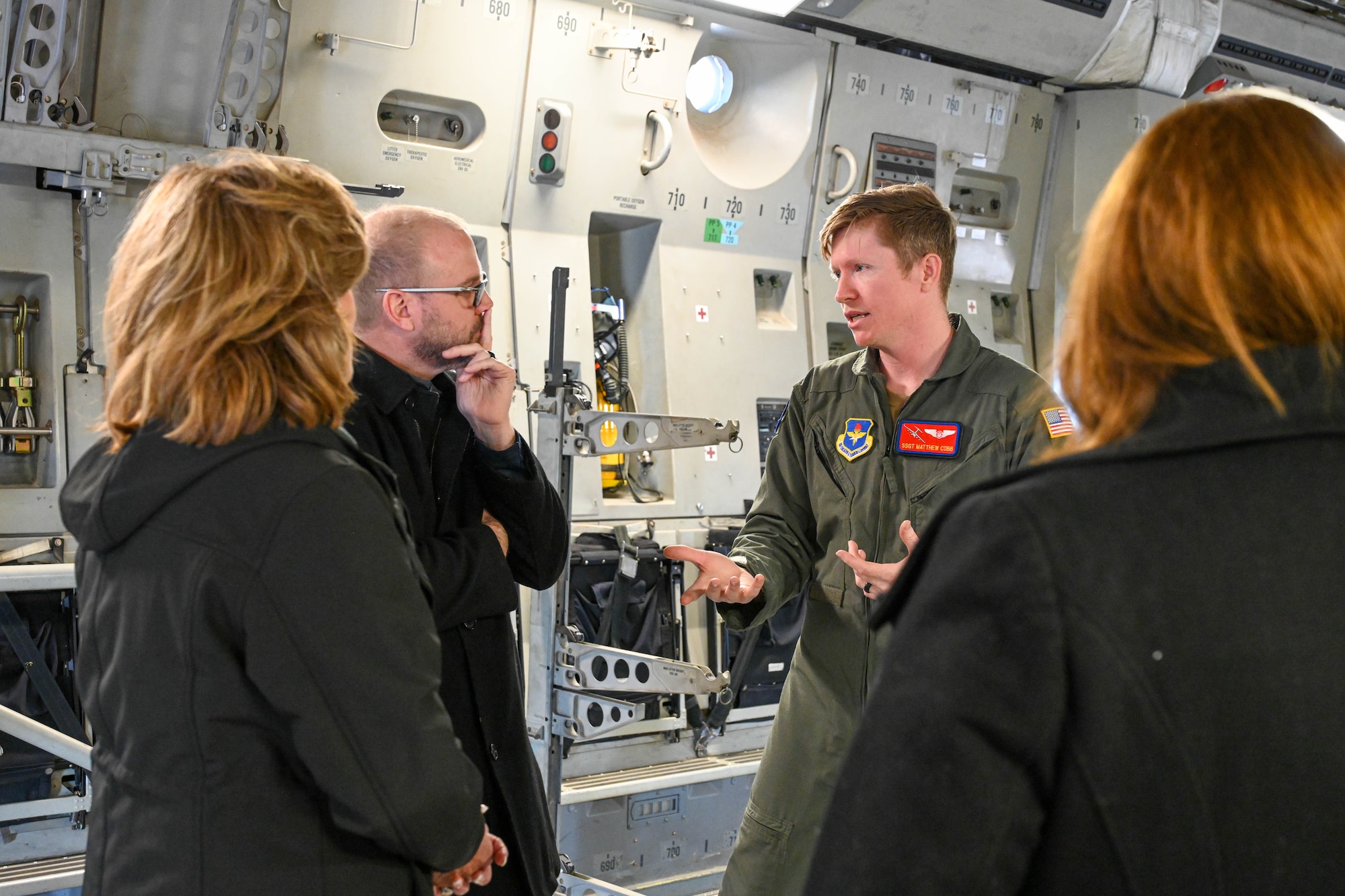 U.S. Air Force Staff Sgt. Matthew Cobb, 58th Airlift Squadron loadmaster instructor, talks with members of Leadership Oklahoma at Altus Air Force Base, Oklahoma, March 14, 2023. Cobb was able to answer questions about what role loadmasters haveon the C-17 Globemaster III and what equipment they are responsible to operate. (U.S. Air Force photo by Senior Airman Trenton Jancze)