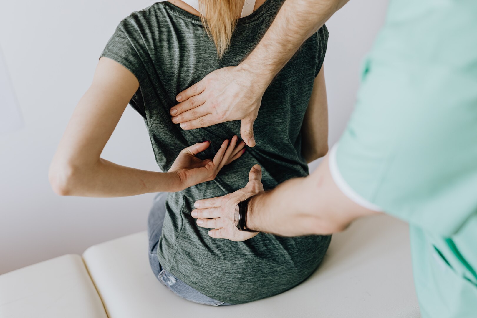 A doctor adjusts a woman's back