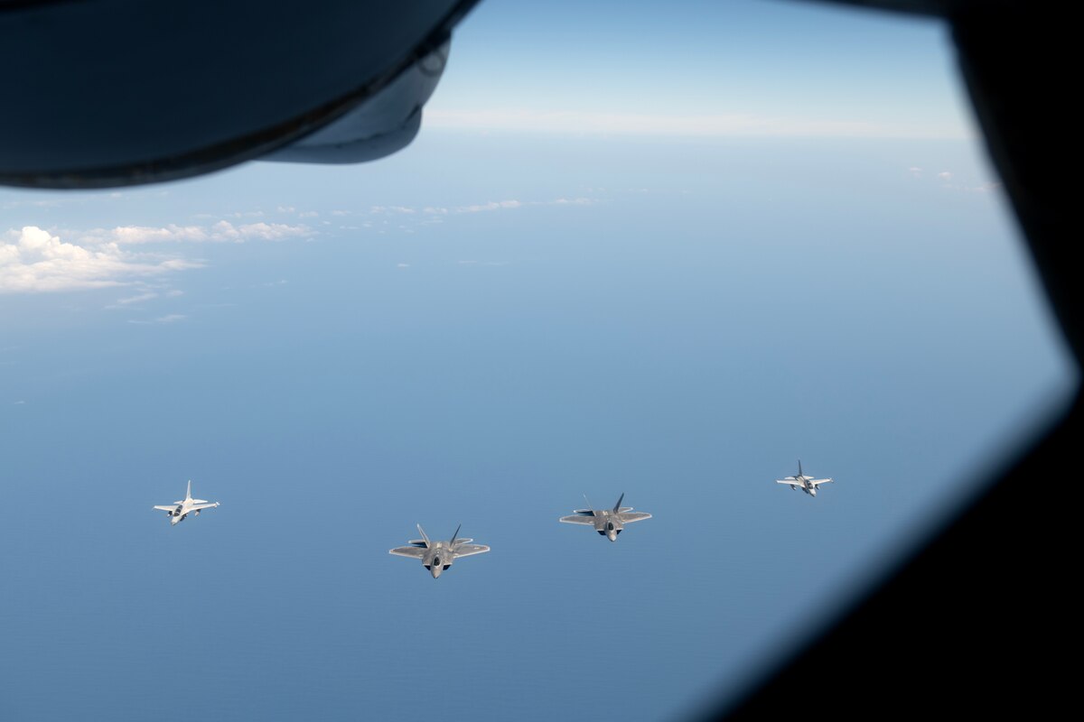F-22A Raptors assigned to the 525th Fighter Squadron fly in formation with Philippine Air Force FA-50PH aircraft over the South China Sea, March 14, 2023. Integrating and training alongside the Philippine Air Force promotes interoperability, builds upon our strong alliance, and reaffirms the commitment to the Mutual Defense Treaty and maintaining peace and stability throughout the Indo-Pacific region. (U.S. Air Force photo by Senior Airman Jessi Roth)