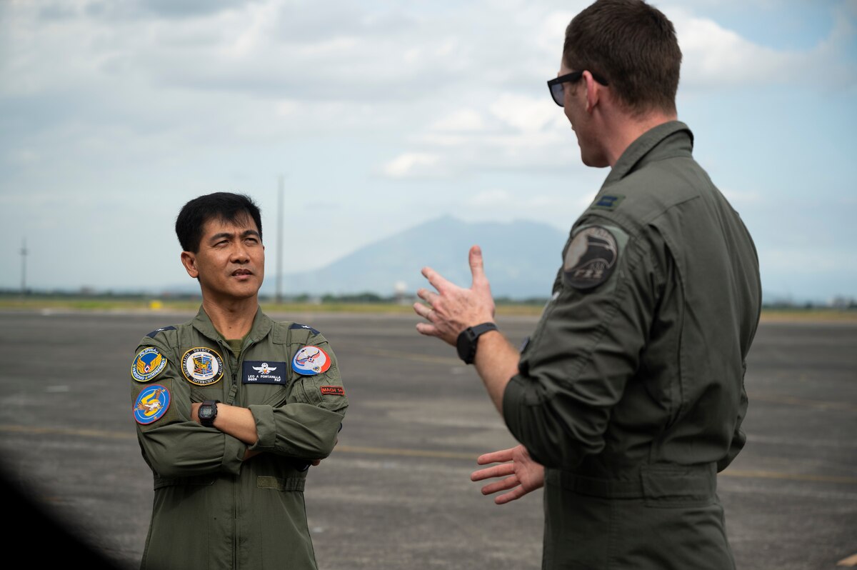 U.S. Air Force Capt. Karl Schroeder, 525th Fighter Squadron F-22A Raptor pilot, briefs Philippine Air Force Brig. Gen. Leo Fontanilla, 5th Fighter Wing commander, on the capabilities of the Raptor during a static aircraft tour at Clark Air Base, Philippines, March 13, 2023. These exchanges promote interoperability and build upon the foundation of a strong U.S.-Philippines alliance while reaffirming the PACAF commitment to the Indo-Pacific region. (U.S. Air Force photo by Senior Airman Jessi Roth)
