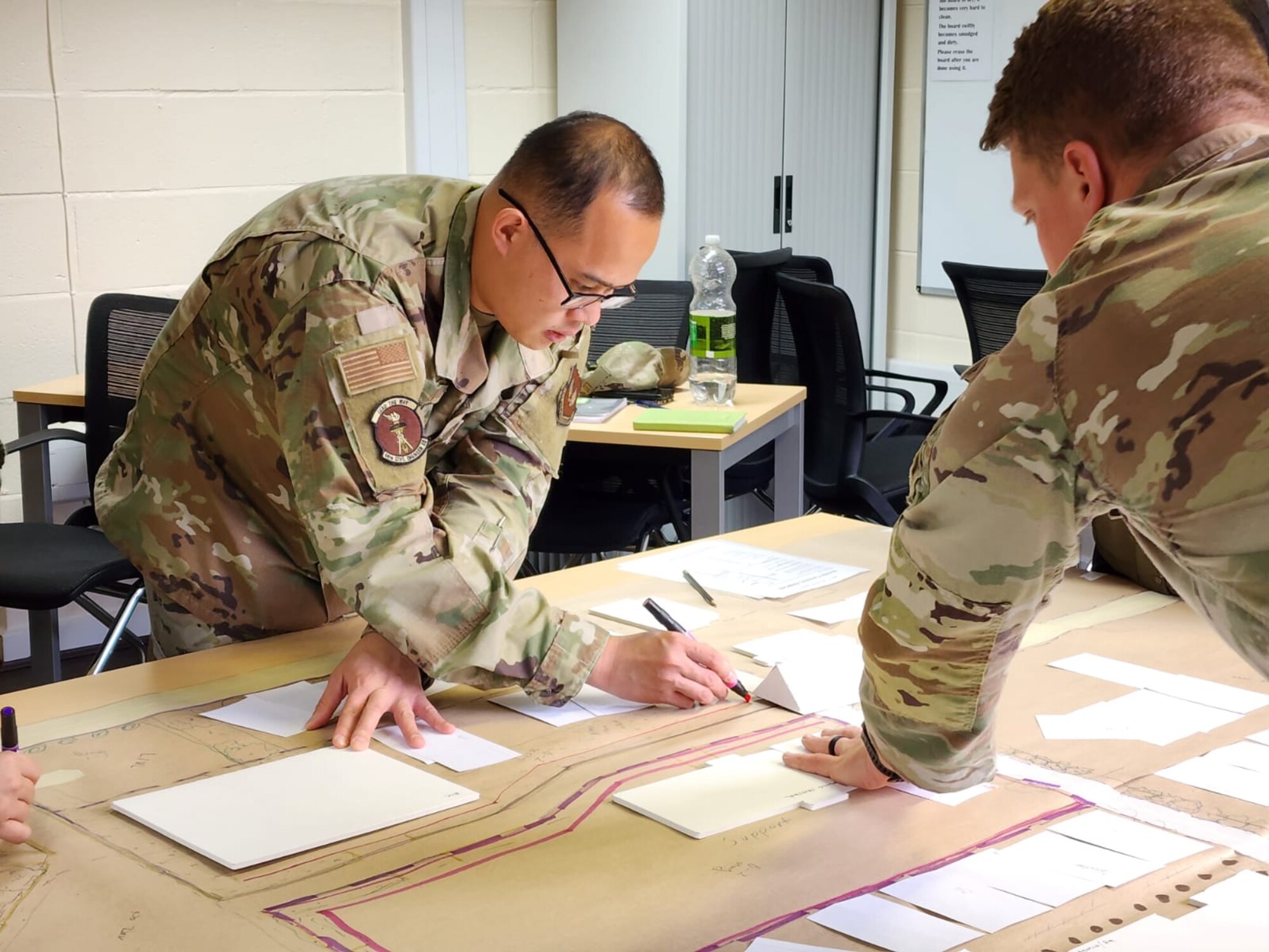 Staff Sgt. Howard Lu (left) works on a real-world area-development plan for RAF Feltwell, England, as part of the first off-site offering of Air Force Institute of Technology Civil Engineer School’s Comprehensive Planning Course. (Contributed photo)