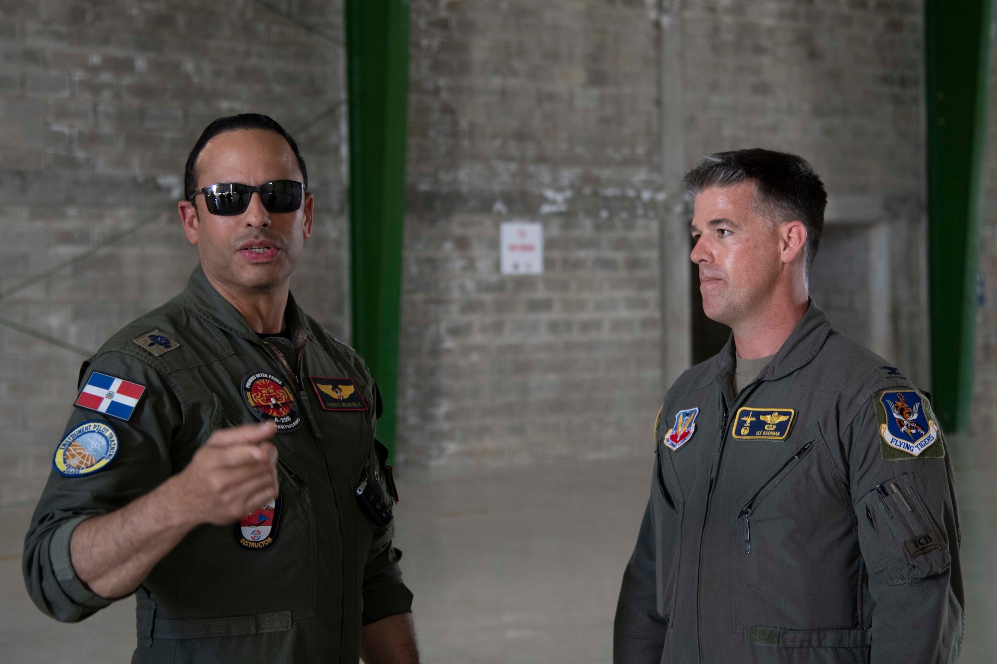 A Fuerza Aérea de República Dominicana officer, left, discusses exercise Forward Tiger with U.S. Air Force Col. Sean Baerman, 23rd Fighter Group commander, at San Isidro Air Base, Dominican Republic, Feb. 16, 2023. Exercise Forward Tiger was designed to build on longstanding partnerships throughout the Caribbean and contribute to enhanced military readiness, humanitarian relief, and disaster response capabilities. (U.S. Air Force photo by 1st Lt. Christian Little)