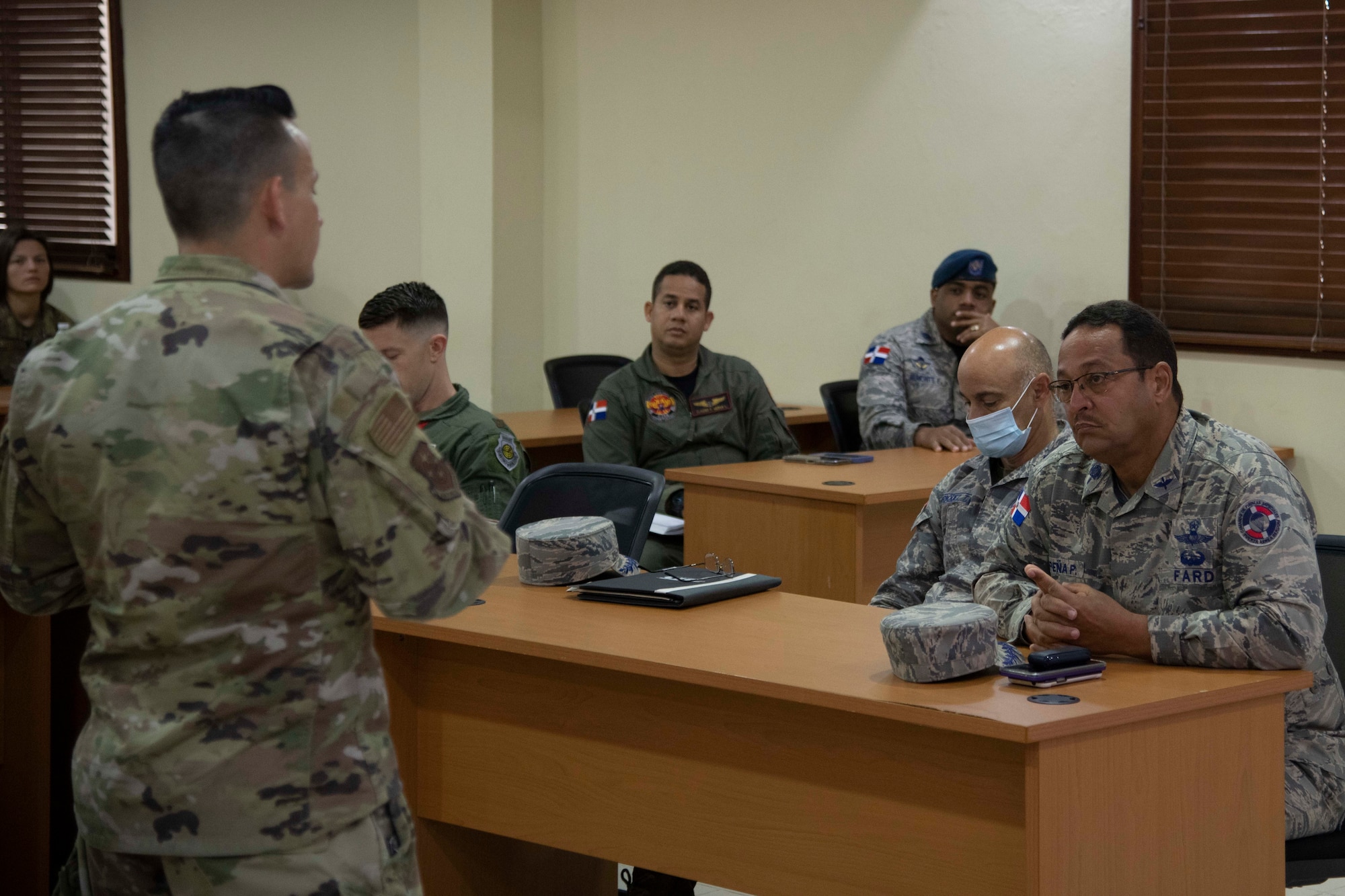 Fuerza Aérea de República Dominicana and U.S. Air Force Airmen discuss exercise Forward Tiger at San Isidro Air Base, Dominican Republic, Feb. 16, 2023. Exercise Forward Tiger was designed to build on longstanding partnerships throughout the Caribbean and contribute to enhanced military readiness, humanitarian relief, and disaster response capabilities. (U.S. Air Force photo by 1st Lt. Christian Little)