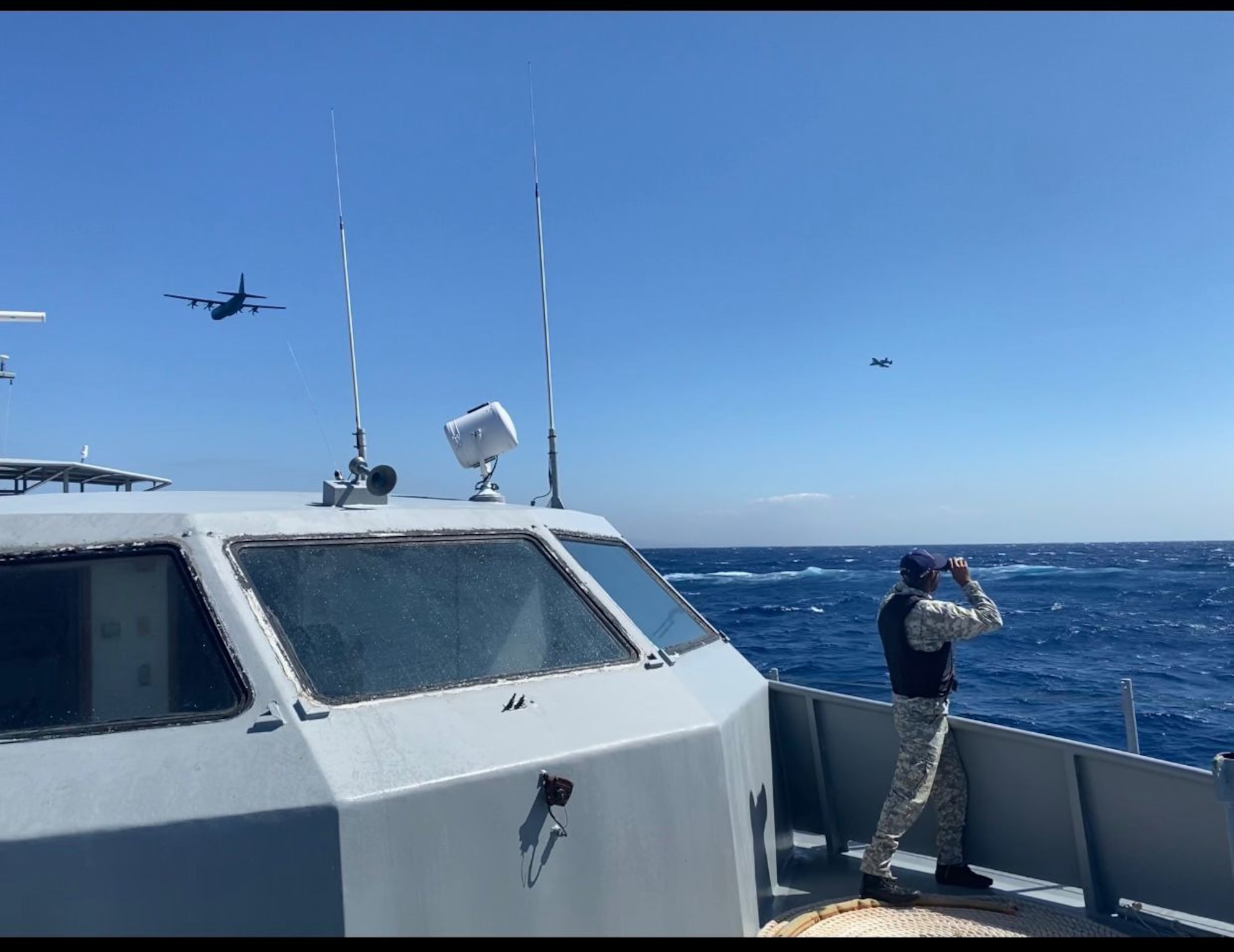 An A-10C Thunderbolt II and C-130J Super Hercules fly near a Dominican Republic Navy ship above the Caribbean Sea off the southern coast of the Dominican Republic, Feb. 22, 2023. This ship was taking part in air and maritime integration with U.S. Air Force's 23rd Air Expeditionary Wing during Operation Forward Tiger to improve interoperability and expertise for both forces. (Dominican Republic Navy courtesy photo)