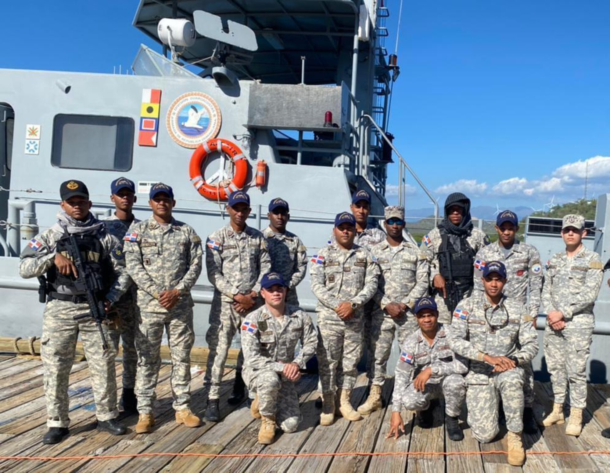 A Dominican Republic Navy ship's crew poses for a group photo while operating in the Caribbean Sea off the southern coast of the Dominican Republic, Feb. 21, 2023. This ship and its crew were taking part in air and maritime integration with U.S. Air Force's 23rd Air Expeditionary Wing during Operation Forward Tiger to improve interoperability and expertise for both forces. (Dominican Republic Navy courtesy photo)