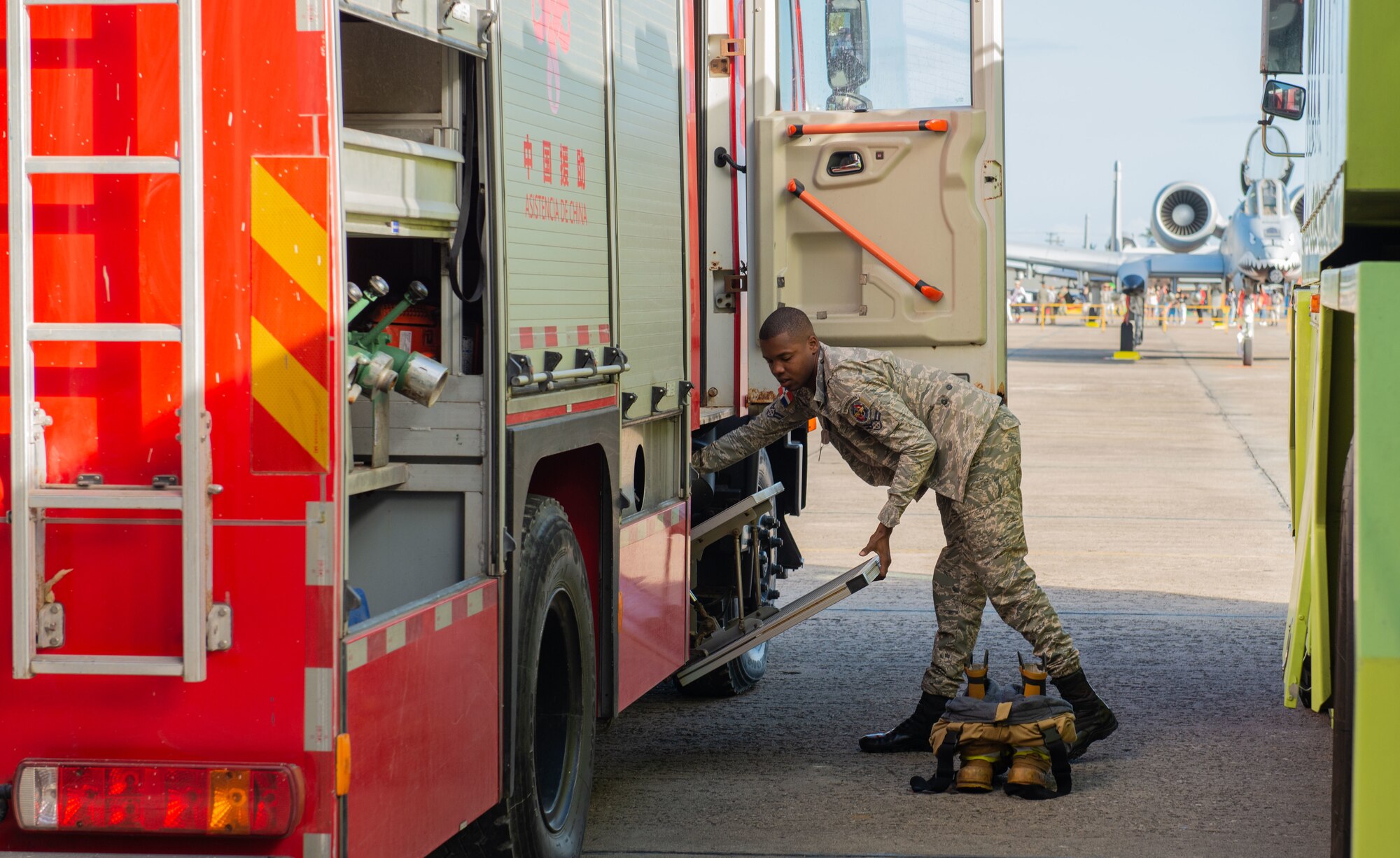 A member of the Dominican Republic Air Force (FARD) prepares to gear up in case of an emergency during an airshow at San Isidro Air Base, Dominican Republic, Feb. 19, 2023. The airshow was integrated into Operation Forward Tiger, an exercise designed to build on longstanding partnerships throughout the Caribbean and contribute to enhanced military readiness, humanitarian relief, and disaster response capabilities. (U.S. Air Force photo by Tech. Sgt. Jessica H. Smith-McMahan)