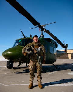 Senior Airman Garrett Hightower (left), 54th Helicopter Squadron (HS) flight engineer, lowers Airman 1st Class Caulder Taylor (bottom center), 54th HS special missions aviator, to the ground with a rescue hoist from a UH-1N Huey in rural North Dakota, March 13, 2023. 54th HS helicopters typically fly from ground level to 2,000 feet above ground level. Operations may require flight up to 15,000 feet above mean sea level. (U.S. Air Force photo by Staff Sgt. Michael A. Richmond)