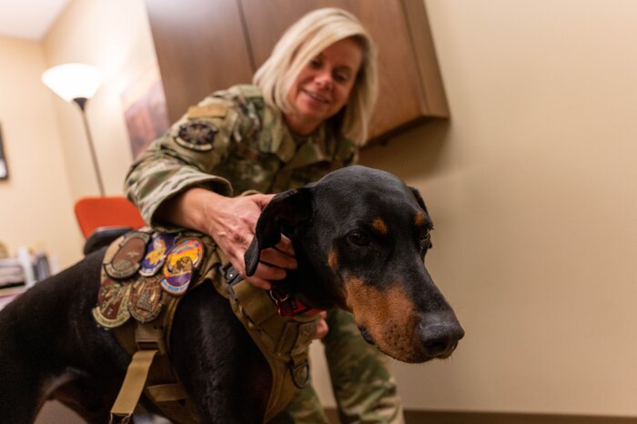 Master Sgt. Danielle Graham, 934th Aeromedical Staging Squadron medical case manager, pets Tech. Sgt. Diesel, the 934 ASTS therapeutic dog at the Minneapolis-St. Paul Air Reserve Station on March 5, 2023. Diesel was picked for his position because he has a relaxed demeanor, enjoys being petted and likes meeting new people. (Senior Airman Colten Tessness)