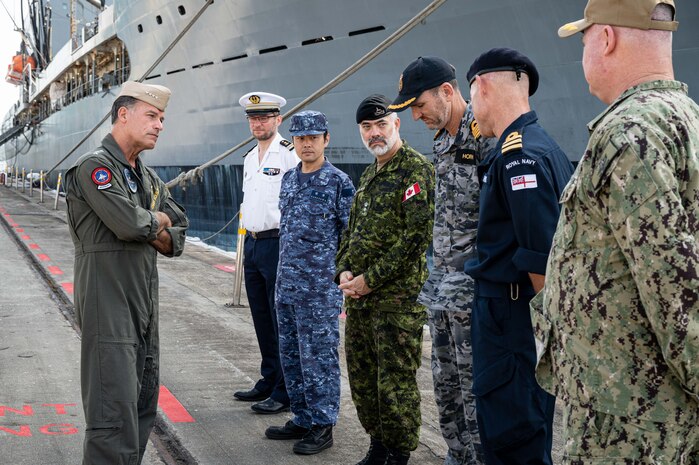 SINGAPORE (March 16, 2023) Adm. John C. Aquilino, Commander U.S. Indo-Pacific Command, left, meets with Sailors from France, Japan, Canada, Australia and the United Kingdom while visiting a pier at Commander, Logistics Group Western Pacific/ Task Force 73 (COMLOG WESTPAC/ CTF 73) during an overseas trip to Singapore. COMLOG WESTPAC supports deployed surface units and aircraft carriers, along with regional Allies and partners, to facilitate patrols in the South China Sea, participation in naval exercises and responses to natural disasters. USINDOPACOM is committed to enhancing stability in the Asia-Pacific region by promoting security cooperation, encouraging peaceful development, responding to contingencies, deterring aggression and, when necessary, fighting to win. (U.S. Navy photo by Chief Mass Communication Specialist Shannon M. Smith)