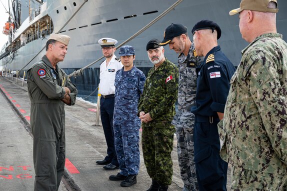SINGAPORE (March 16, 2023) Adm. John C. Aquilino, Commander U.S. Indo-Pacific Command, left, meets with Sailors from France, Japan, Canada, Australia and the United Kingdom while visiting a pier at Commander, Logistics Group Western Pacific/ Task Force 73 (COMLOG WESTPAC/ CTF 73) during an overseas trip to Singapore. COMLOG WESTPAC supports deployed surface units and aircraft carriers, along with regional Allies and partners, to facilitate patrols in the South China Sea, participation in naval exercises and responses to natural disasters. USINDOPACOM is committed to enhancing stability in the Asia-Pacific region by promoting security cooperation, encouraging peaceful development, responding to contingencies, deterring aggression and, when necessary, fighting to win. (U.S. Navy photo by Chief Mass Communication Specialist Shannon M. Smith)