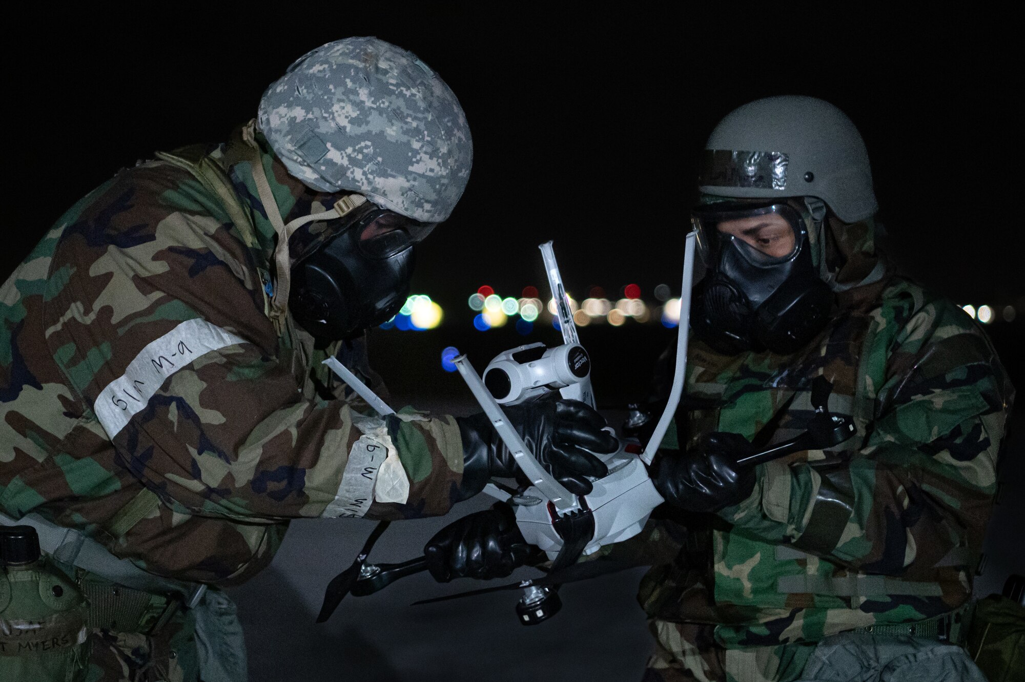 Airmen hold an unmanned aerial vehicle