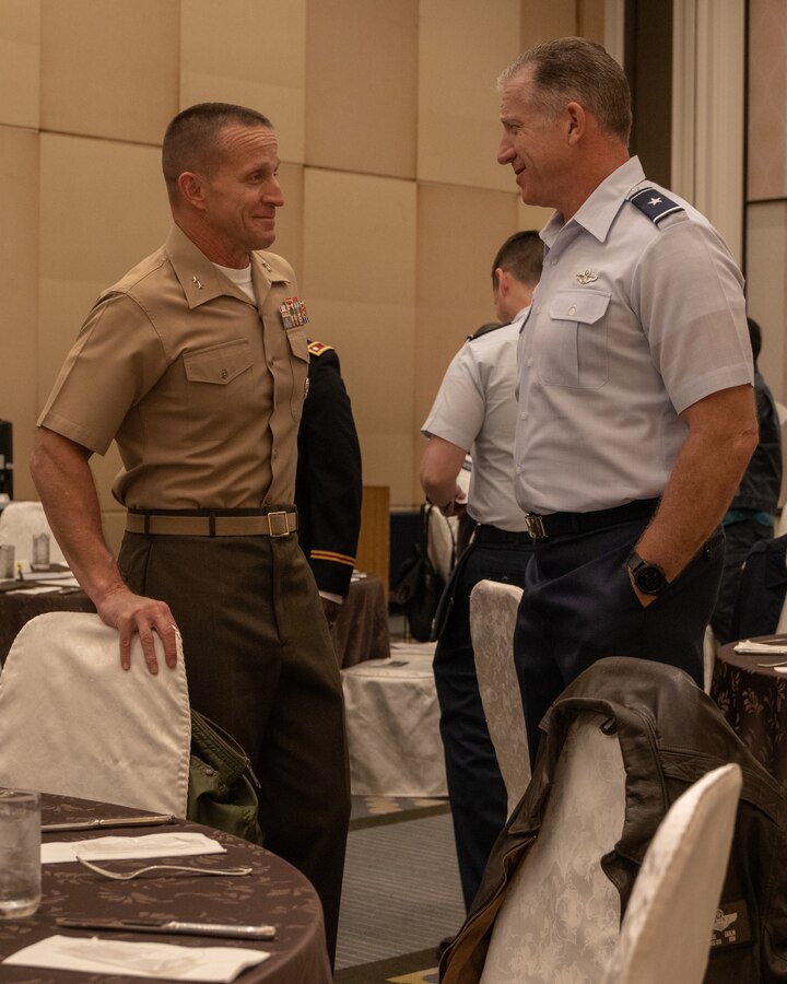 U.S. Marine Corps Maj. Gen. Stephen Liszewski, left, the commanding general of Marine Corps Installations Pacific, and Air Force Brig. Gen. David Eaglin, right, the commanding officer of the 18th Wing, converse during an American Chamber of Commerce in Okinawa meeting at Ginowan, Okinawa, Japan, March 3, 2023. The conference was organized to help promote business between the U.S. military and Japanese entrepreneurs with ACCO. ACCO was established in 1953 to unite business growth and American success among affiliates. Fields commonly joined with ACCO are manufacturing, retail, construction, wholesale, and financial services. (U.S. Marine Corps photo by Lance Cpl. Jonathan Beauchamp)