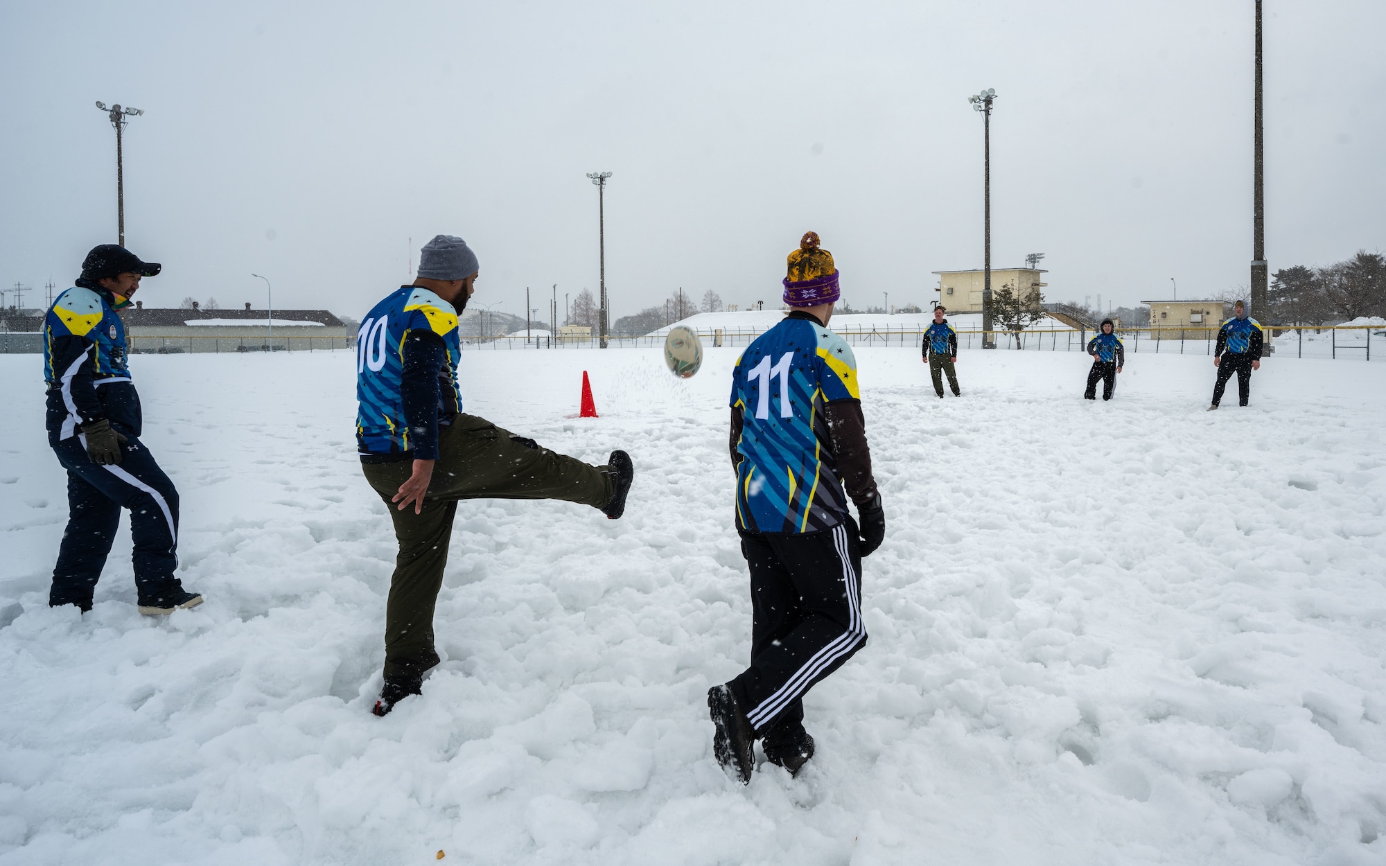 A rugby member kicks a ball