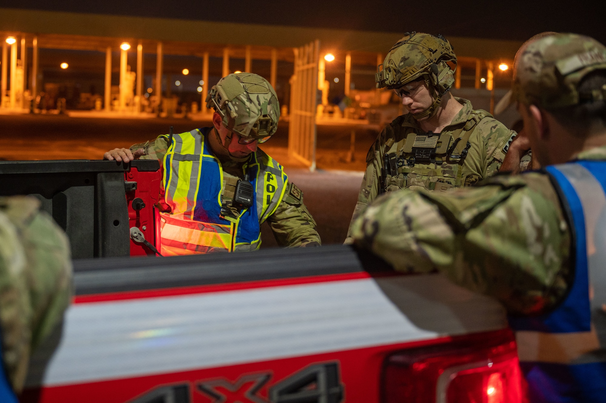 A photo of 379th Expeditionary Civil Engineer Squadron and 379th Expeditionary Security Forces Squadron Airmen having a discussion