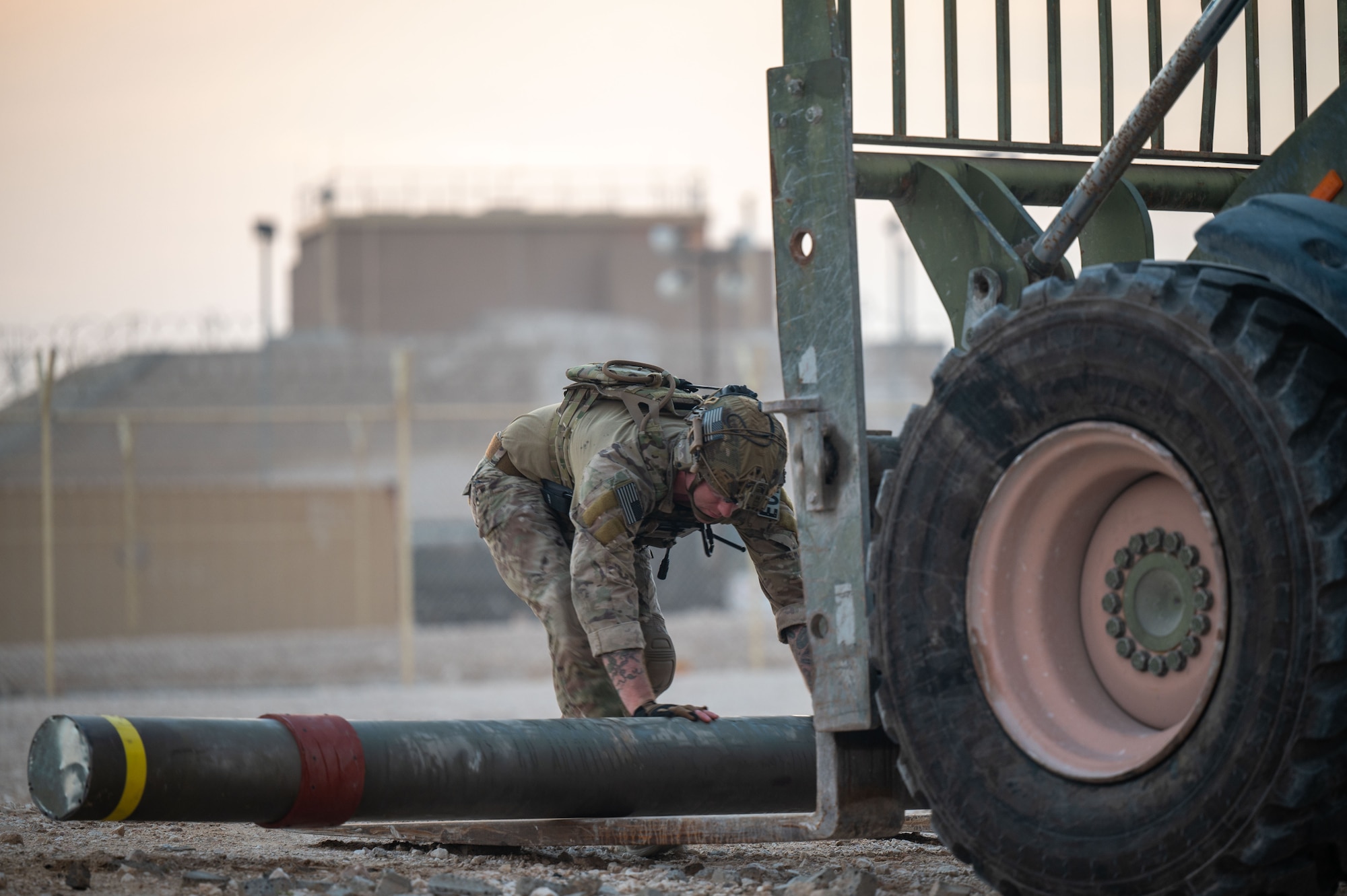 A photo of an explosive ordnance disposal Airman removing an unexploded ordinance