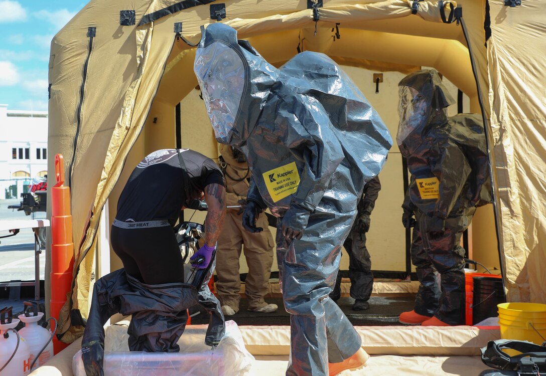 An unidentified Soldier with the New Hampshire National Guards 12th Civil Support teams displays his unit's sweatshirt dAn officer with Louisville Metro Police's Hazardous Incident Response Team gets out of his hazardous material suit after working a simulated scenario with the help of Sgt. 1st Class Daniel Dormbrusch, 12th CST, New Hampshire National Guard during a training event at Churchill Downs in Louisville, Ky., March 14, 2023.