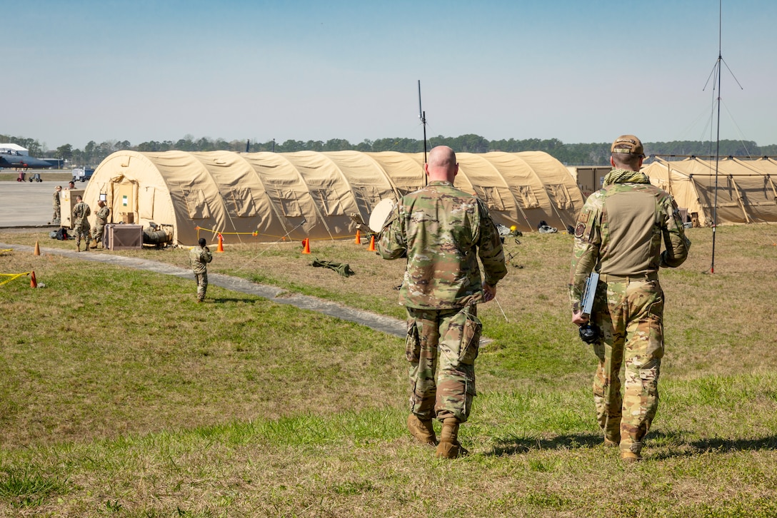 U.S. Air Force Airmen participating in Agile Cub 4 walk to the Wing Operations Center and discuss the day’s schedule at Marine Corps Air Station Cherry Point, North Carolina, March 7, 2023. MCAS Cherry Point's customer service, facilities for training, and restricted airspace and ranges at Bombing Targets 9 and 11, and its proximity to Air Force training sites facilitated readiness training for the 4th Fighter Wing and strengthened relationships between its mission partners. (U.S. Marine Corps photo by Cpl. Noah Braswell)