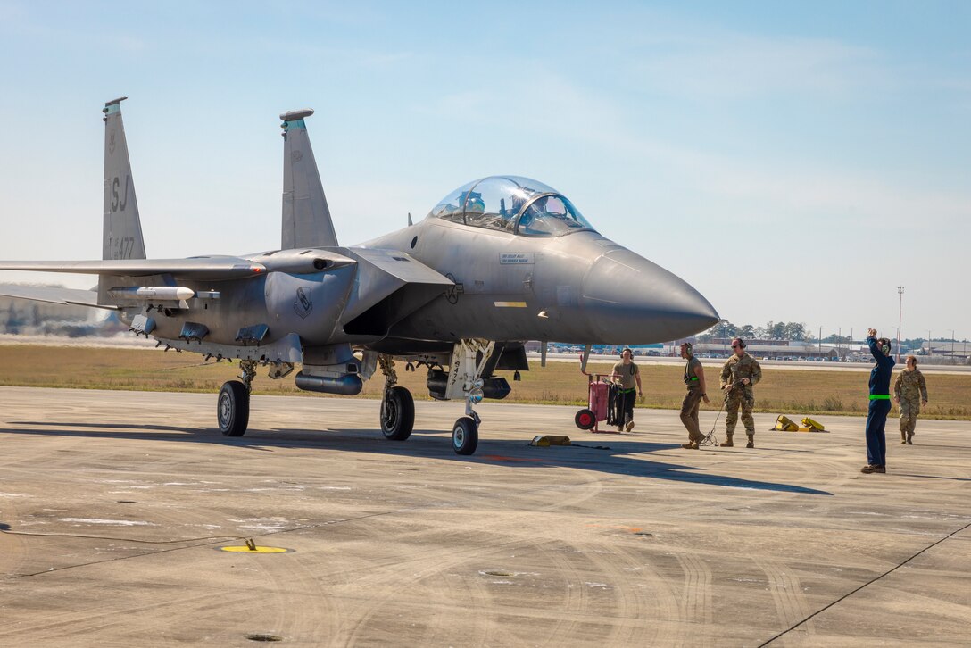 An F-15E Strike Eagle assigned to the 4th Fighter Wing, Seymour Johnson Air Force Base, North Carolina, is guided onto a ramp during Exercise Agile Cub 4 at Marine Corps Air Station Cherry Point, North Carolina, March 7, 2023. MCAS Cherry Point's customer service, facilities for training, and restricted airspace and ranges at Bombing Targets 9 and 11, and its proximity to Air Force training sites facilitated readiness training for the 4th Fighter Wing and strengthened relationships between its mission partners. (U.S. Marine Corps photo by Cpl. Noah Braswell)