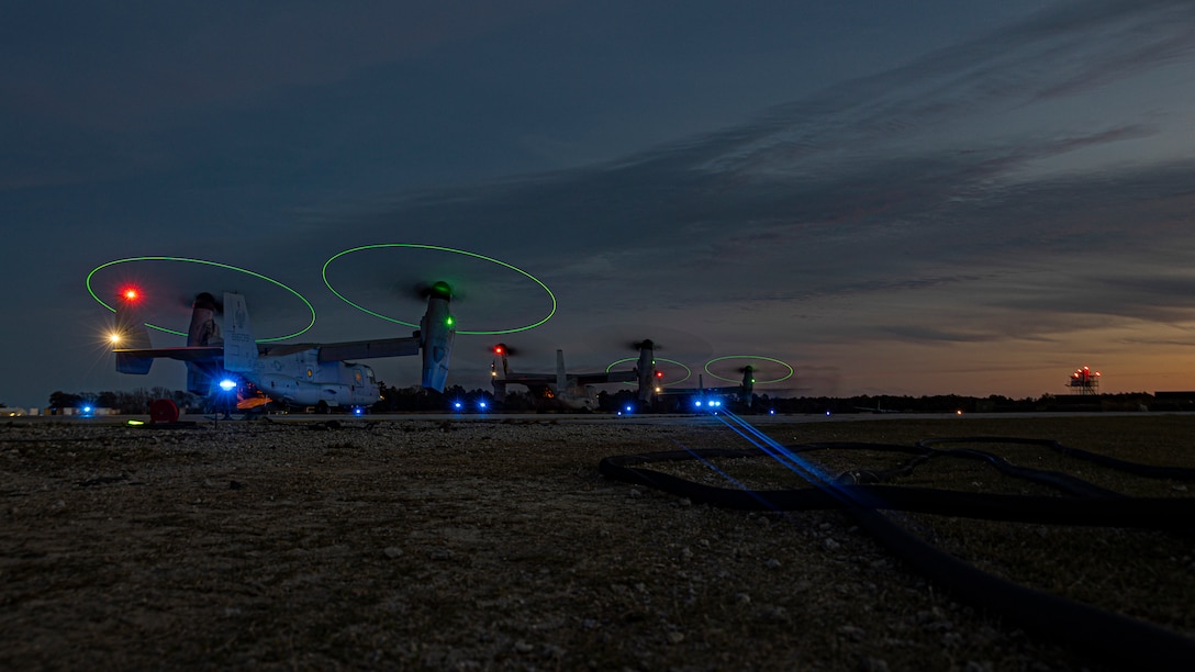U.S. Marine Corps MV-22 Ospreys assigned to Marine Medium Tiltrotor Squadron 162 (VMM-162) Reinforced, await orders to take off and begin the start of a full mission profile raid during MEU Exercise (MEUEX) III on Marine Corps Auxiliary Landing Field Bogue, North Carolina, March 9, 2023. The raid was part of a scenario during MEUEX III designed to sharpen the MEU’s ability to conduct critical mission essential tasks and become more lethal in preparation for the upcoming deployment. (U.S. Marine Corps photo by Cpl. Matthew Romonoyske-Bean)