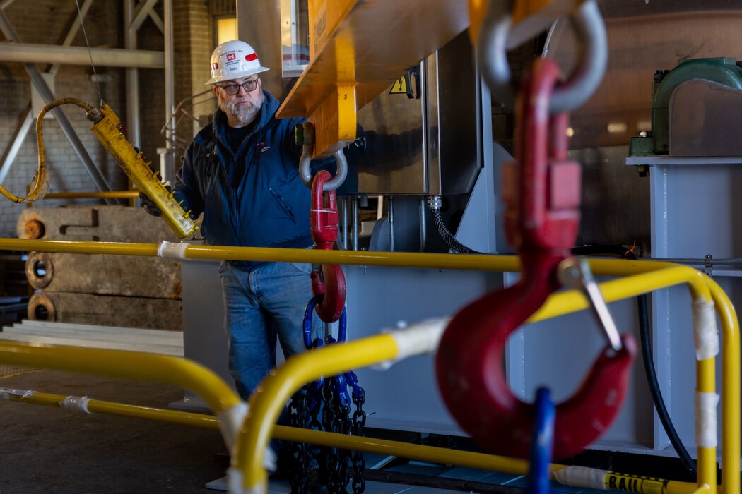 Brent Kelly, a maintenance mechanic, prepares a lifting beam to lift a new gate hoist during its installation in the control tower at the Crooked Creek Dam in Ford City, Pennsylvania, Feb. 14, 2023. BCI Construction installed four new hoists – each weighing 38,000 pounds apiece and control the dam’s gates – at Crooked Creek Lake to modernize the facility’s machinery and improve usage. The new hoists make the machinery safer and more efficient to use, with digital displays that are more accurate and easier to read. The original hoists were in operation since the dam was built in 1938. (U.S. Army Corps of Engineers photo by Andrew Byrne)