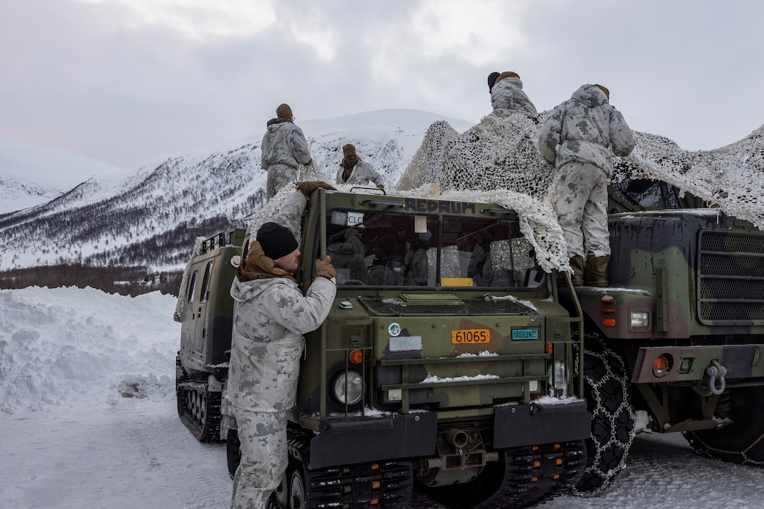U.S. Marines with Combat Logistics Battalion 2, Combat Logistics Regiment 2, 2nd Marine Logistics Group, set up camouflage netting to conceal vehicles during Exercise Joint Viking near Bardufoss, Norway, March 11, 2023. Marines are deployed to Norway as part of Marine Rotational Forces Europe 23.1 which focuses on regional engagements throughout Europe by conducting various exercises, arctic cold-weather and mountain warfare training, and military-to-military engagements, which enhance overall interoperability of the U.S. Marine Corps with allies and partners. (U.S. Marine Corps photo by Sgt. Christian M. Garcia)