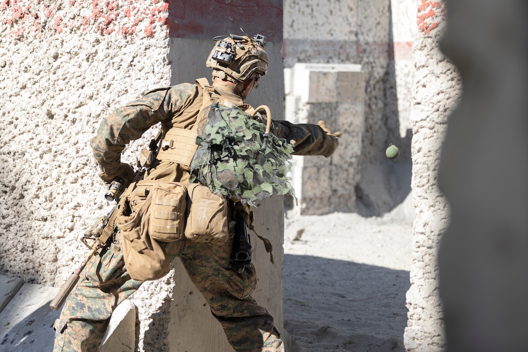 A U.S. Marine with Alpha Company, Battalion Landing Team (BLT) 1/6, 26th Marine Expeditionary Unit (MEU), throws a M67 hand grenade into a room at a range part of Military Operations in Urban Terrain (MOUT) town on Marine Corps Base Camp Lejeune, North Carolina, March 11, 2023. MOUT training increases the lethality of the MEU’s infantrymen through live-fire drills, room clearing procedures and small team tactics in order to prepare for their upcoming deployment. (U.S. Marine Corps photo by Cpl. Matthew Romonoyske-Bean)