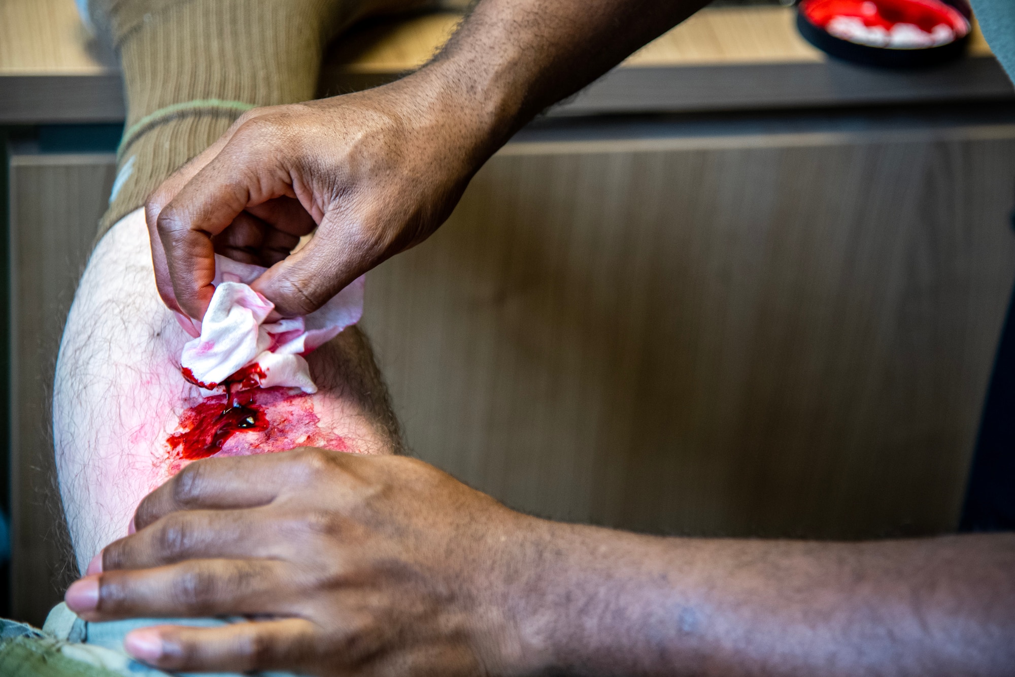 Moulage is applied to a simulated victim at RAF Alconbury, England, March 16, 2023. The simulation was part of an exercise which tested the 501st Combat Support Wing on overall readiness and ability to respond to an emergency situation. (U.S. Air Force photo by Staff Sgt. Eugene Oliver)