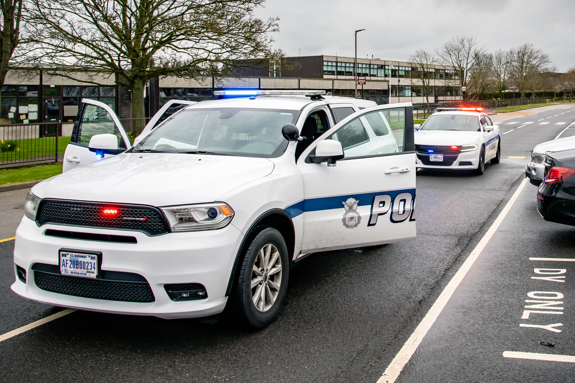 Airmen from the 423d Security Forces Squadron arrive at an active shooter exercise scene at RAF Alconbury, England, March 16, 2023. The exercise tested the 501st Combat Support Wing on overall readiness and ability to respond to an emergency situation. (U.S. Air Force photo by Staff Sgt. Eugene Oliver)