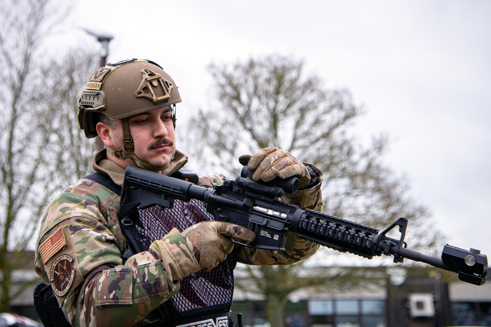 U.S. Air Force Staff Sgt. Andres Cabrera, 423d Security Forces Squadron flight sergeant, inspects his weapon during an exercise at RAF Alconbury, England, March 16, 2023. The exercise tested the 501st Combat Support Wing on overall readiness and ability to respond to an emergency situation. (U.S. Air Force photo by Staff Sgt. Eugene Oliver)