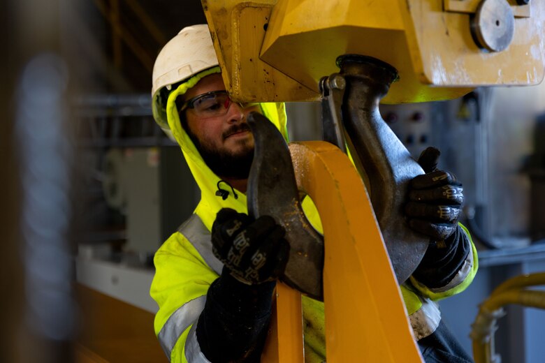Parker Mathis, a contractor with BCI Construction USA, hooks the lifting beam to the overhead crane to install a new gate hoist in the Crooked Creek Dam control tower in Ford City, Pennsylvania, Feb. 14, 2023. BCI Construction installed four new hoists – each weighing 38,000 pounds apiece and control the dam’s gates – at Crooked Creek Lake to modernize the facility’s machinery and improve usage. The new hoists make the machinery safer and more efficient to use, with digital displays that are more accurate and easier to read. The original hoists were in operation since the dam was built in 1938. (U.S. Army Corps of Engineers photo by Andrew Byrne)
