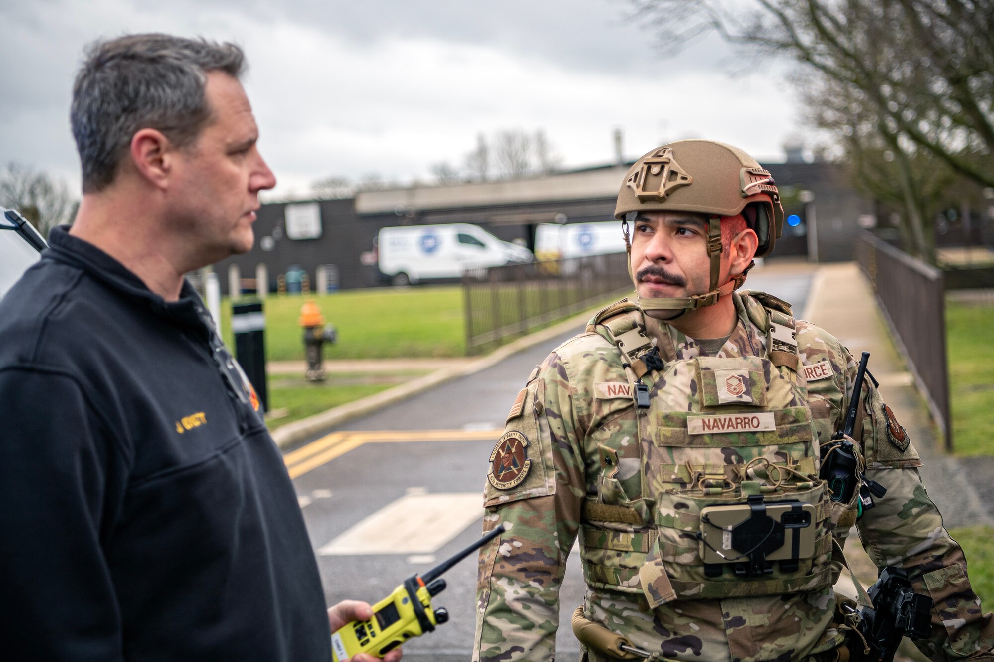 U.S. Air Force Master Sgt. Christian Navarro-Salazar, right, 423d Security Forces Squadron supply and logistics superintendent, speaks with Jeremy Evett, 423d Civil Engineer Squadron fire chief, during an active shooter exercise at RAF Alconbury, England, March 16, 2023. The exercise tested the 501st Combat Support Wing on overall readiness and ability to respond to an emergency situation. (U.S. Air Force photo by Staff Sgt. Eugene Oliver)