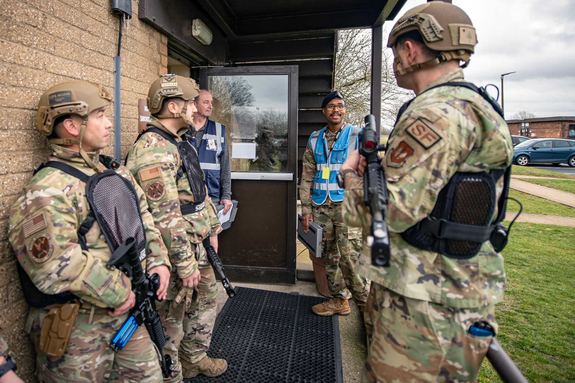 Airmen from the 423d Security Forces Squadron discuss their response following an active shooter exercise at RAF Alconbury, England, March 16, 2023. The exercise tested the 501st Combat Support Wing on overall readiness and ability to respond to an emergency situation. (U.S. Air Force photo by Staff Sgt. Eugene Oliver)