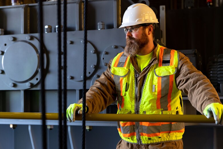 Brian Butler, a contractor with BCI Construction USA, overseeing the hoist installation in the Crooked Creek Dam control tower in Ford City, Pennsylvania, Feb. 14, 2023. BCI Construction installed four new hoists – each weighing 38,000 pounds apiece and control the dam’s gates – at Crooked Creek Lake to modernize the facility’s machinery and improve usage. The new hoists make the machinery safer and more efficient to use, with digital displays that are more accurate and easier to read. The original hoists were in operation since the dam was built in 1938. (U.S. Army Corps of Engineers photo by Andrew Byrne)