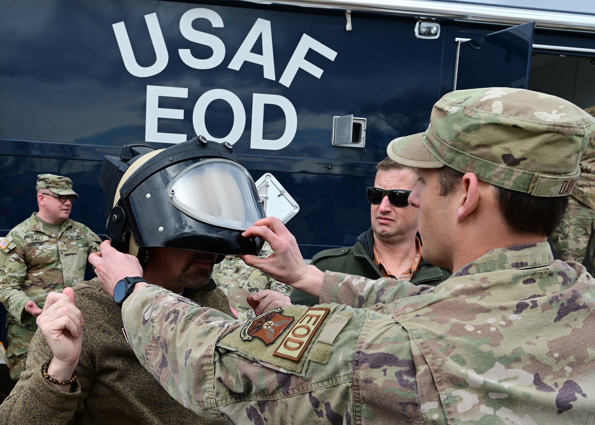 airman putting helmet on visitor