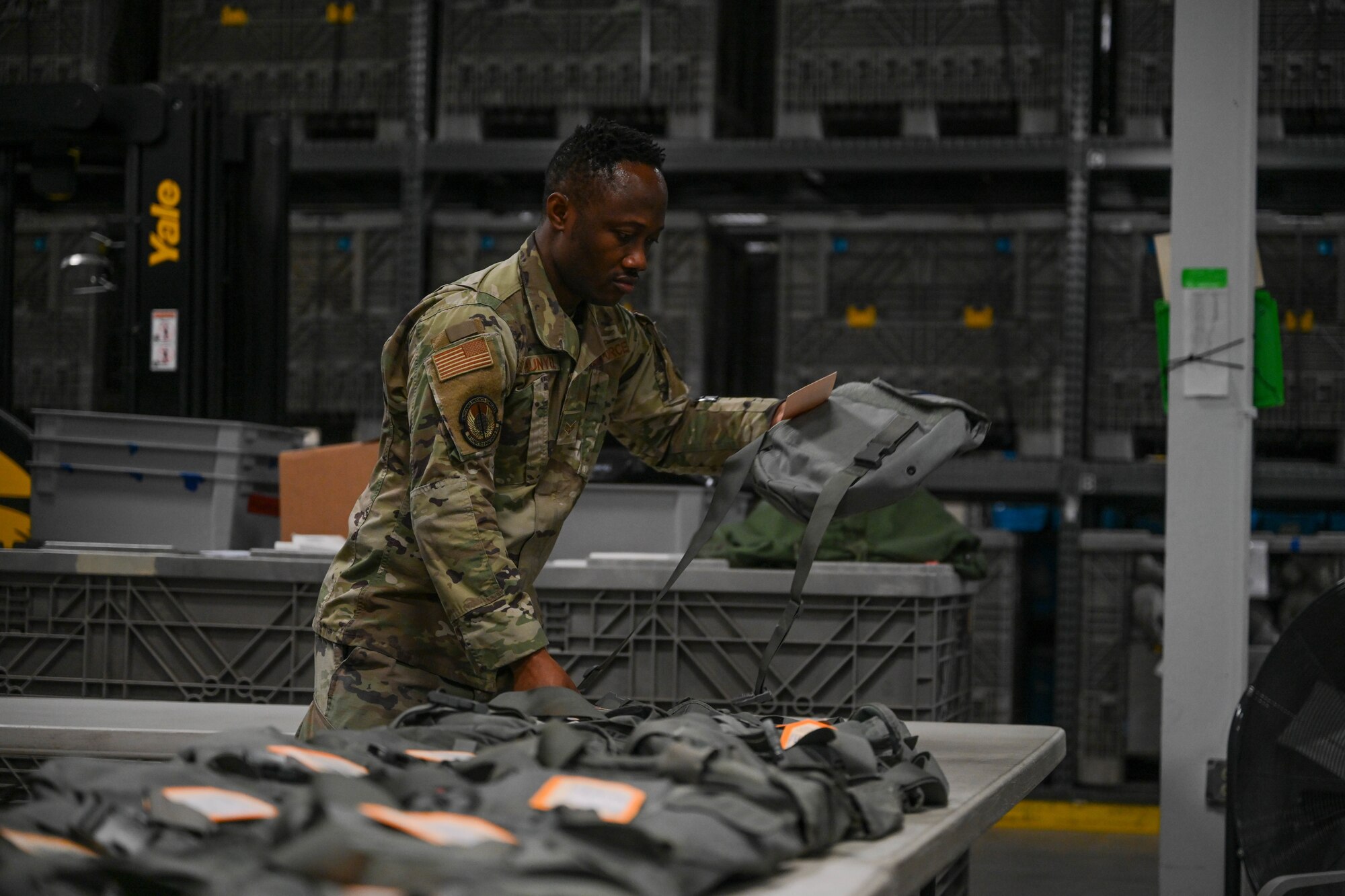 A man in uniform organizes bags.