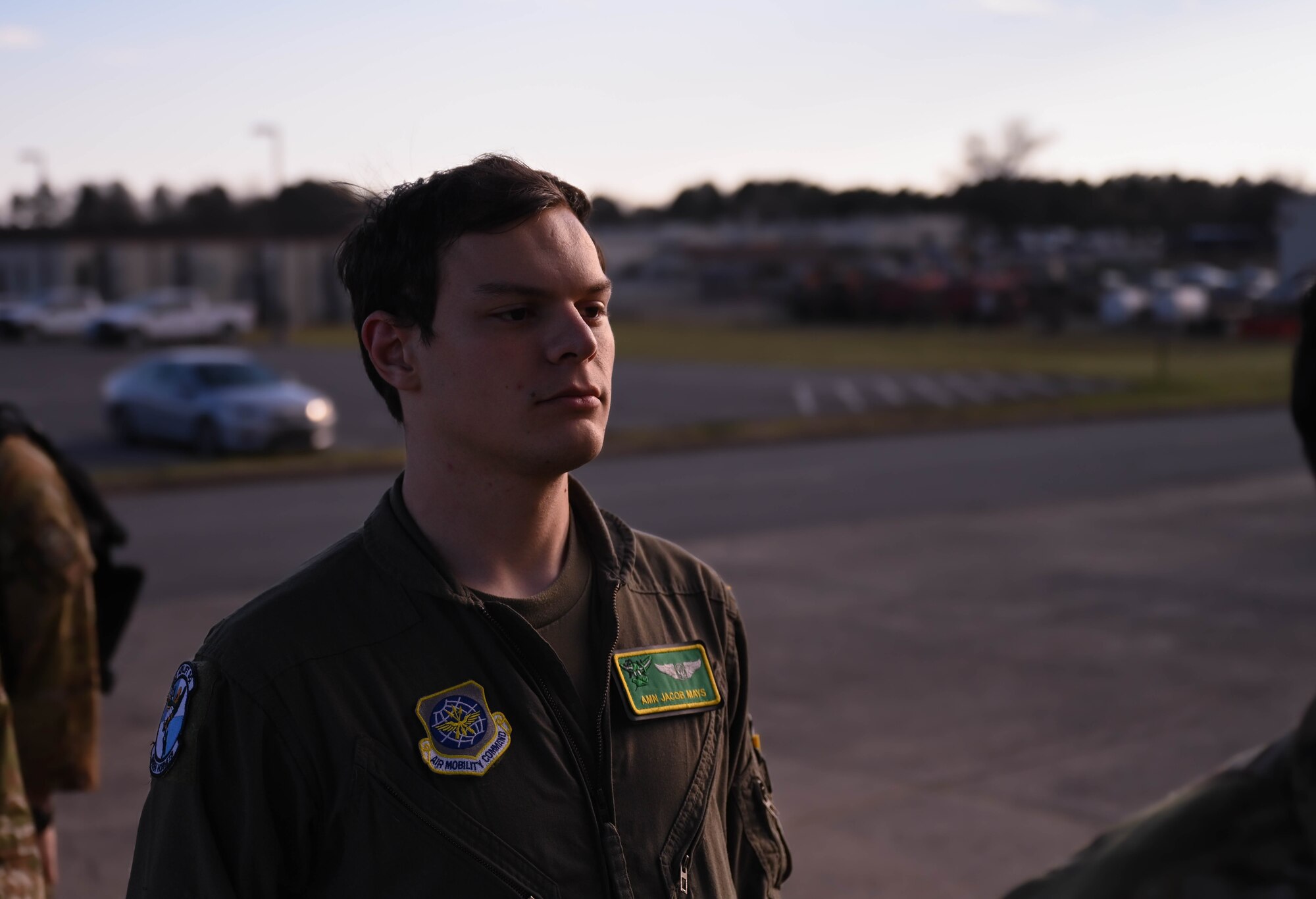 A man in uniform looks into the distance.