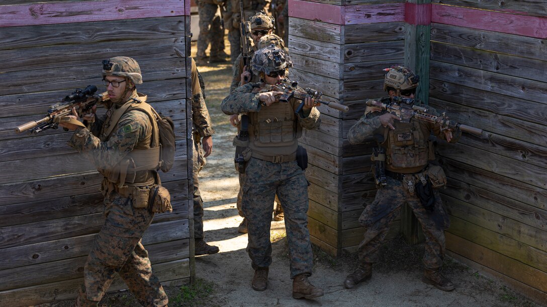 Elements of the 26th Marine Expeditionary Unit’s (MEU) Battalion Landing Team (BLT) 1/6, clear a room at a grenade range part of Military Operations in Urban Terrain (MOUT) training during MEU Exercise III on Marine Corps Base Camp Lejeune, North Carolina, March 11, 2023. MOUT training increases the lethality of the MEU’s infantrymen through live-fire drills, room clearing procedures and small team tactics in order to prepare for their upcoming deployment. (U.S. Marine Corps photo by Cpl. Matthew Romonoyske-Bean)