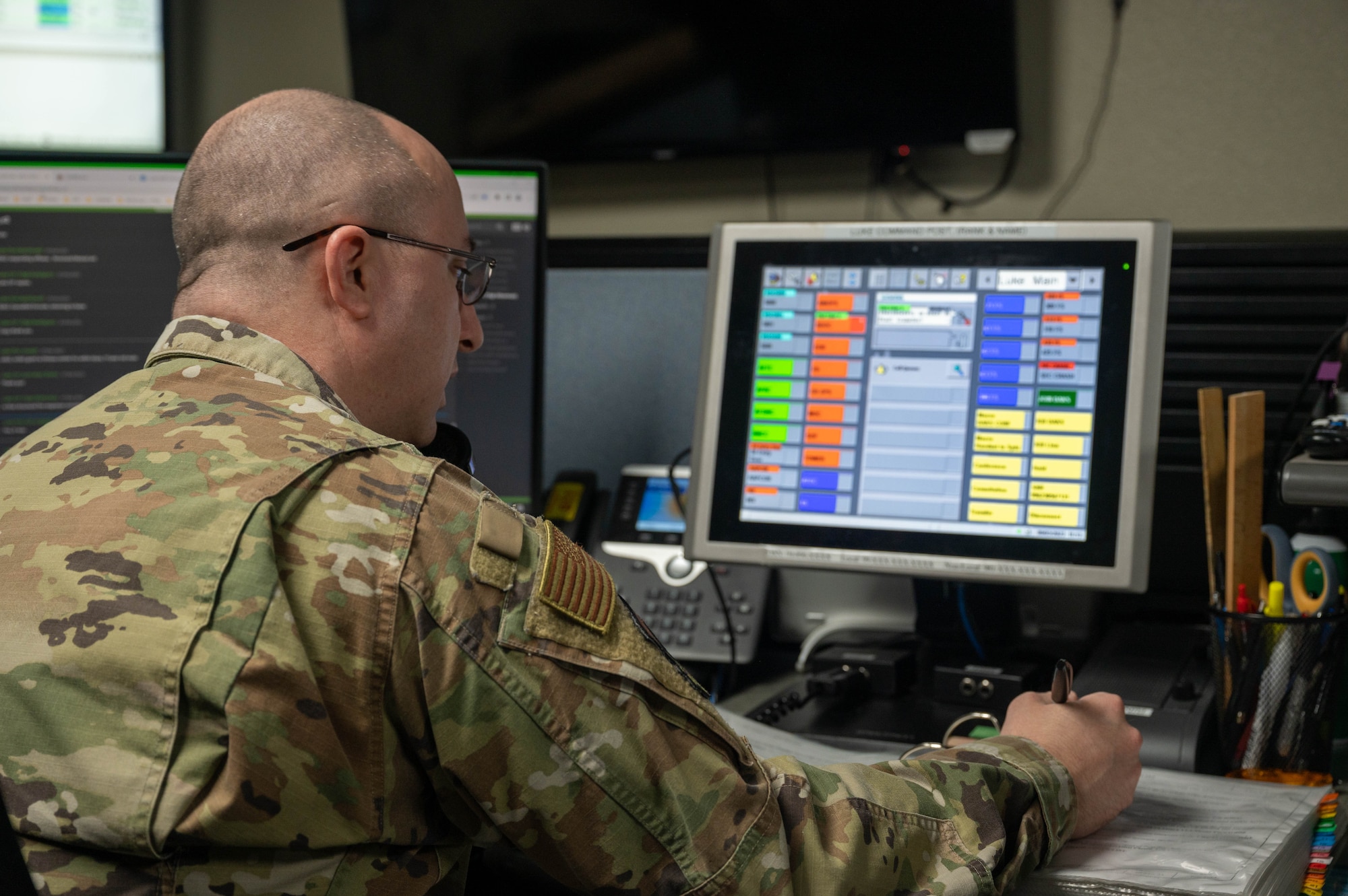 U.S. Air Force Tech. Sgt. Robert Silverman, 56th Fighter Wing Command Post operations non-commissioned officer in charge, speaks on the phone during required hourly checks, March 9, 2023, at Luke Air Force Base, Arizona.