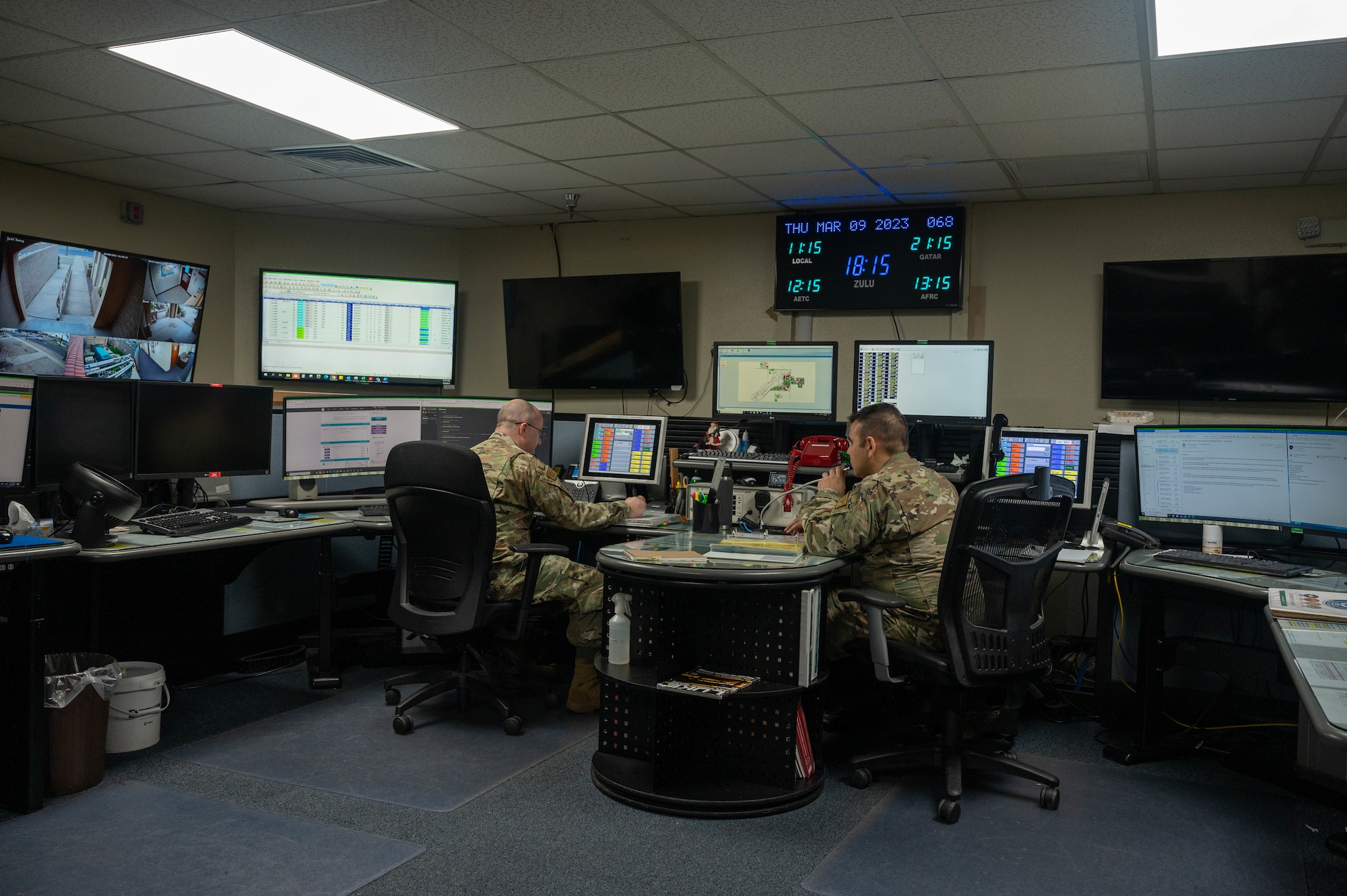U.S. Air Force Tech. Sgt. Miguel Rodriguez, 56th Fighter Wing Command Post systems non-commissioned officer in charge, and Tech Sgt. Robert Silverman, 56th FW Command Post operations NCOIC, monitor various information sources, March 9, 2023, at Luke Air Force Base, Arizona.