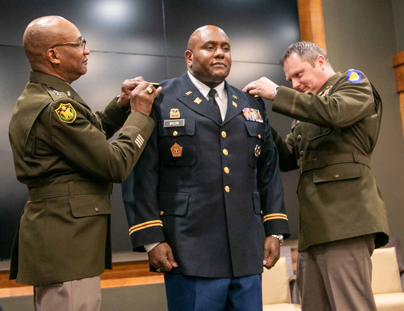 Maj. Gen. Rodney Boyd, Assistant Adjutant General-Army and Commander of the Illinois Army National Guard, and Lt. Col. Andrew Adamczyk, Deputy Director, Strategic Planning and Policy, Illinois National Guard, pin new rank on newly-promoted Maj. Anthony McClain, Security Cooperations Officer, and Director, Diversity, Equity and Inclusion, Illinois National Guard, during a promotion ceremony March 17 at the Illinois Military Academy on Camp Lincoln, Springfield, Illinois.