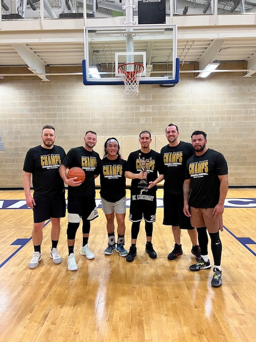 Six basketball players staning on the Hill AFB court