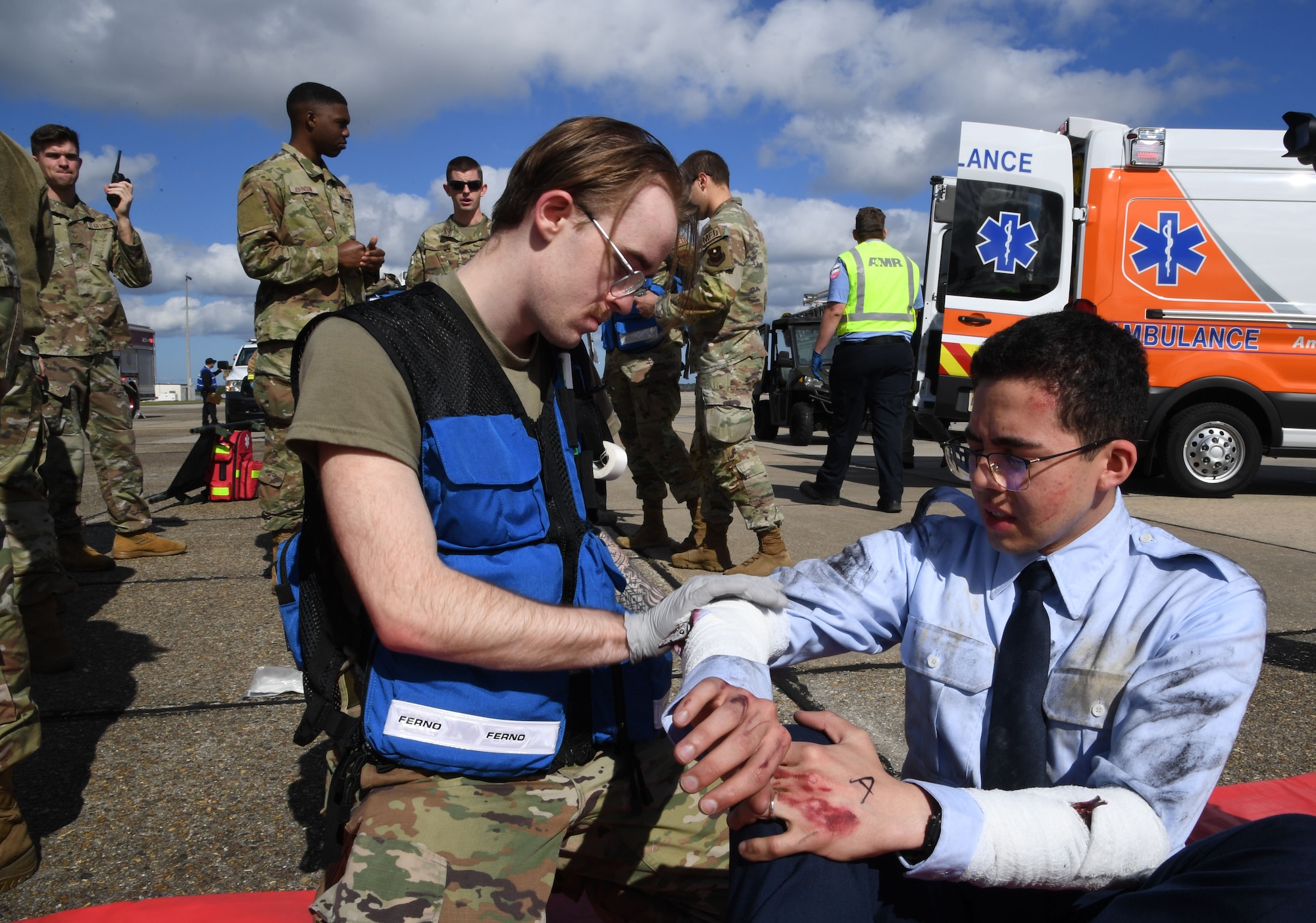U.S. Air Force Airman 1st Class Tyler Sloan, 81st Operational Medical Readiness Squadron medical technician, wraps a simulated arm wound on Airman Christopher Rivas, 334th Training Squadron student, during the aircraft mishap exercise at Keesler Air Force Base, Mississippi, March 16, 2023.