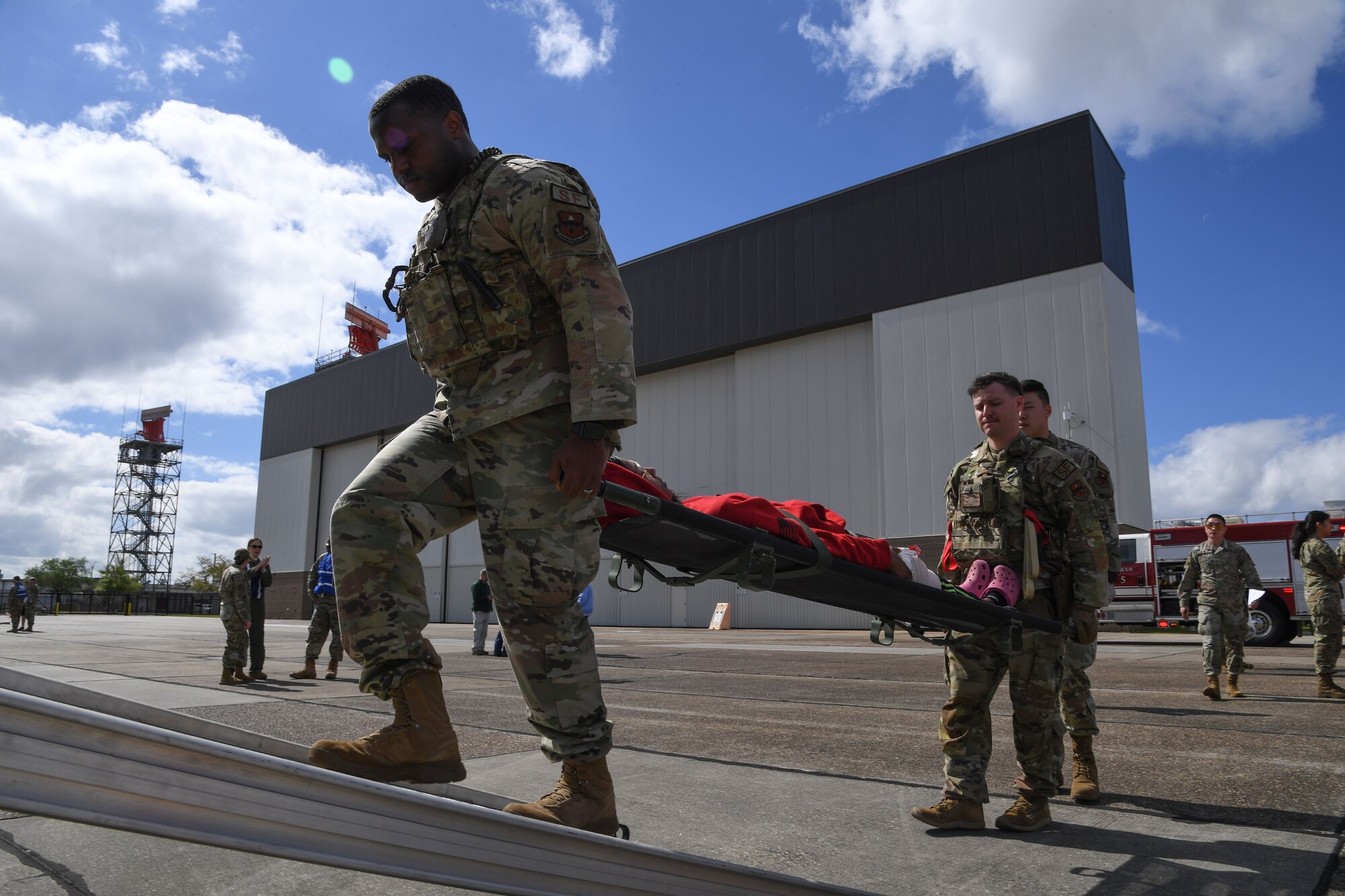 Members of the 81st Medical Group transport a simulated patient to an ambulance during the aircraft mishap exercise at Keesler Air Force Base, Mississippi, March 16, 2023.
